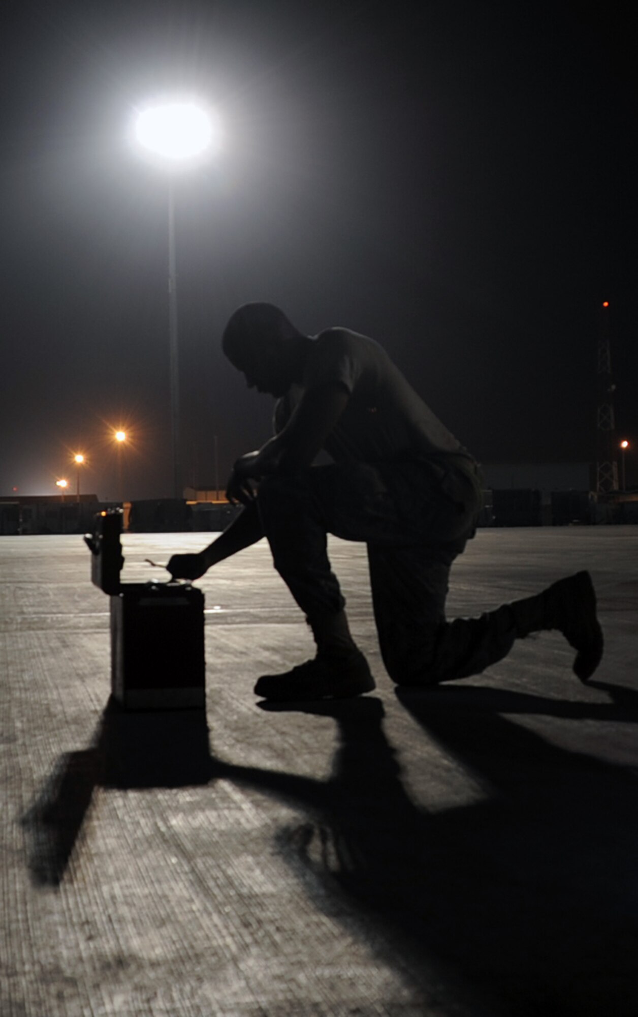 Senior Airman Justin Lassiter, a KC-10 Extender aerospace propulsion journeyman deployed with the 380th Expeditionary Aircraft Maintenance Squadron, reaches into a toolbox while working a night shift at a non-disclosed base in Southwest Asia. Here he is pictured on Jan. 31, 2010.  His primary mission is to fix and maintain KC-10 aircraft engines and systems. He is on his third deployment with the 380th EAMXS. Airman Lassiter is deployed from the 605th Aircraft Maintenance Squadron at Joint Base McGuire-Dix-Lakehurst, N.J., and his hometown is Wilson, N.C. (U.S. Air Force Photo/Master Sgt. Scott T. Sturkol/Released)