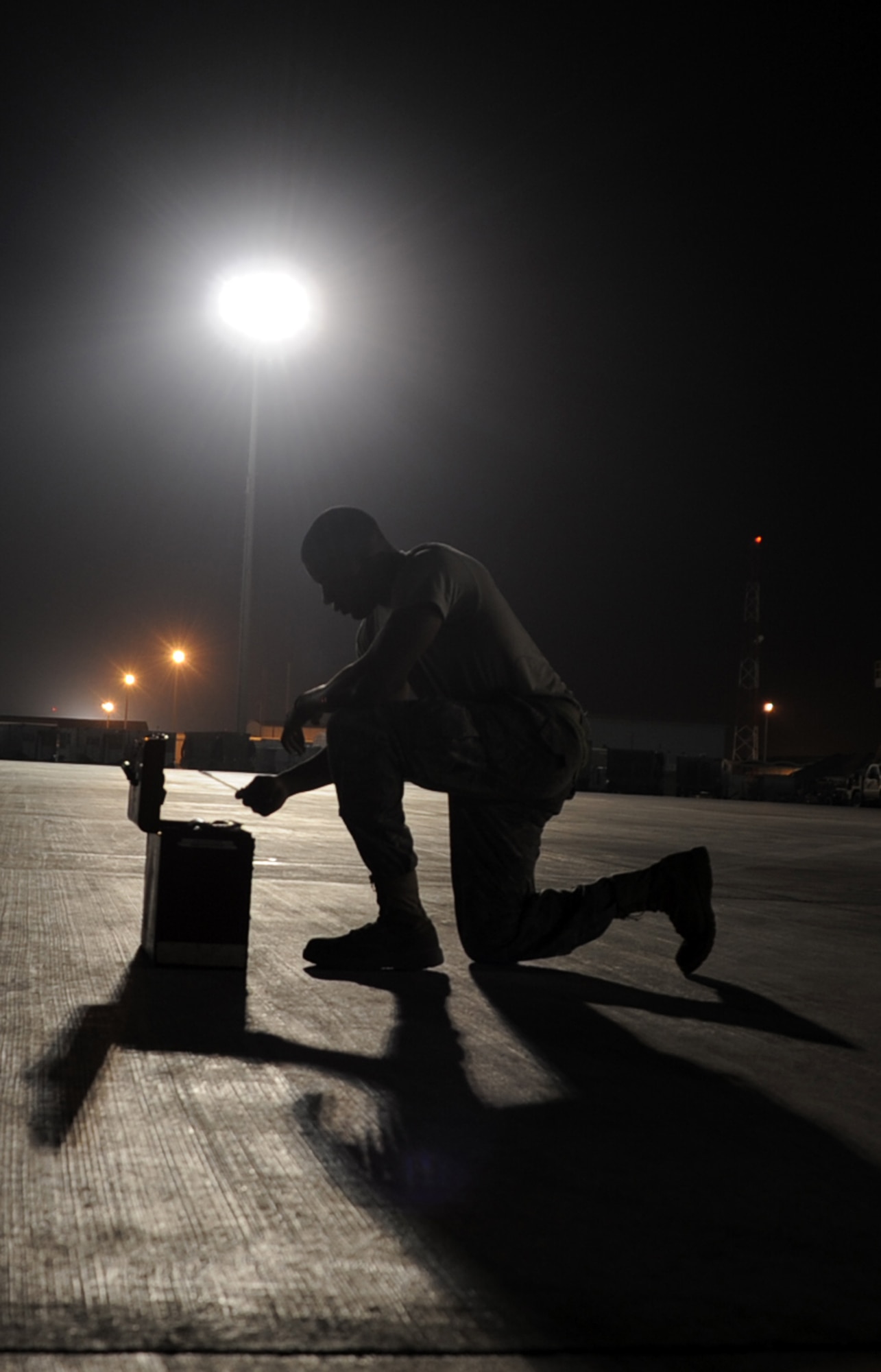 Senior Airman Justin Lassiter, a KC-10 Extender aerospace propulsion journeyman deployed with the 380th Expeditionary Aircraft Maintenance Squadron, reaches into a toolbox while working a night shift at a non-disclosed base in Southwest Asia. Here he is pictured on Jan. 31, 2010.  His primary mission is to fix and maintain KC-10 aircraft engines and systems. He is on his third deployment with the 380th EAMXS. Airman Lassiter is deployed from the 605th Aircraft Maintenance Squadron at Joint Base McGuire-Dix-Lakehurst, N.J., and his hometown is Wilson, N.C. (U.S. Air Force Photo/Master Sgt. Scott T. Sturkol/Released)
