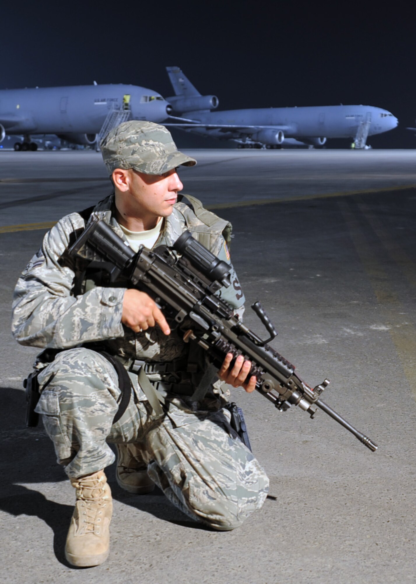 Airman 1st Class Frankie Piland, security forces journeyman with the 380th Expeditionary Security Forces Squadron, watches over the flightline at a non-disclosed base in Southwest Asia on Jan. 31, 2010. Security forces Airmen like Airman Piland are in charge of protecting and providing security for thousands of deployed service members and millions of dollars worth of deployed military assets and equipment. Airman Piland is deployed from the 437th Security Forces Squadron at Charleston Air Force Base, S.C., and his hometown is Seminole, Fla.  (U.S. Air Force Photo/Master Sgt. Scott T. Sturkol/Released)