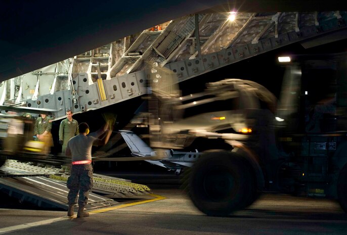 Airmen unload cargo from a C-17 at Aeroport International Toussaint Louverture in Port-au-Prince, Haiti, Jan. 31. The cargo consists of equipment and supplies for supporting relief efforts in Haiti. (U.S. Air Force photo/Staff Sgt. Barry Loo)