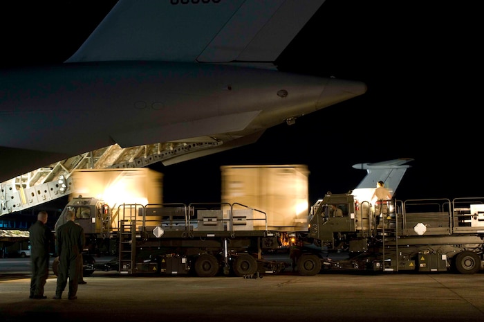 Airmen unload cargo from a C-17 at  Aeroport International Toussaint Louverture in Port-au-Prince, Haiti, Jan. 31. The cargo consists of equipment and supplies for supporting relief efforts in Haiti. (U.S. Air Force photo/Staff Sgt. Barry Loo)