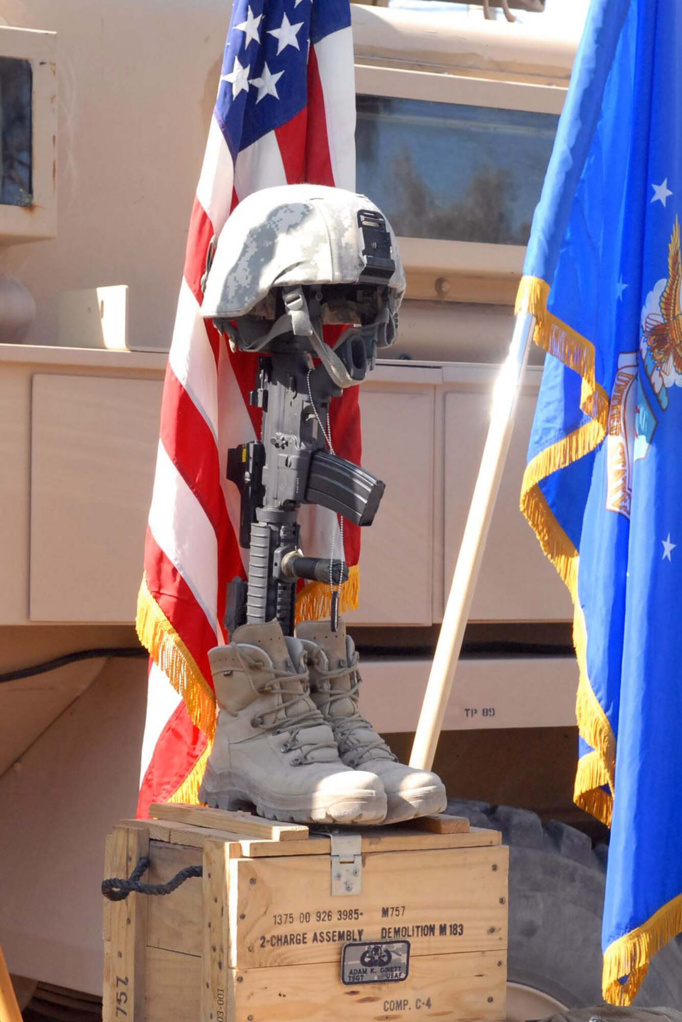 A final memorial tribute to Tech. Sgt. Adam Ginett sits in waiting for his comrades in arms Jan. 24, 2010.  The helmet and identification tags represent the fallen servicemember, the combat boots signify the final march of the last battle and the inverted rifle symbolizes a time for prayer and a break in the action to pay tribute to a fallen comrade. Sergeant Ginett was deployed from Aviano Air Base, Italy to the 755th Air Expeditionary Squadron and was killed in the line of duty Jan. 19.  (U.S. Army photo/Private First Class David Hauk)