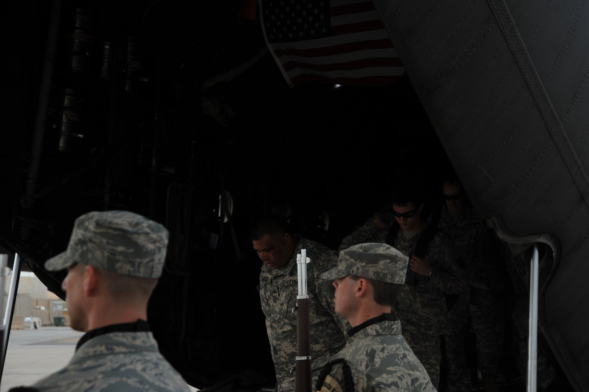 Members of Operation Proper Exit step off a C-130 as they start their tour around Victory Base Complex. Operation Proper Exit is a program where service members who have been injured in Iraq revisit to help bring emotional closure. 