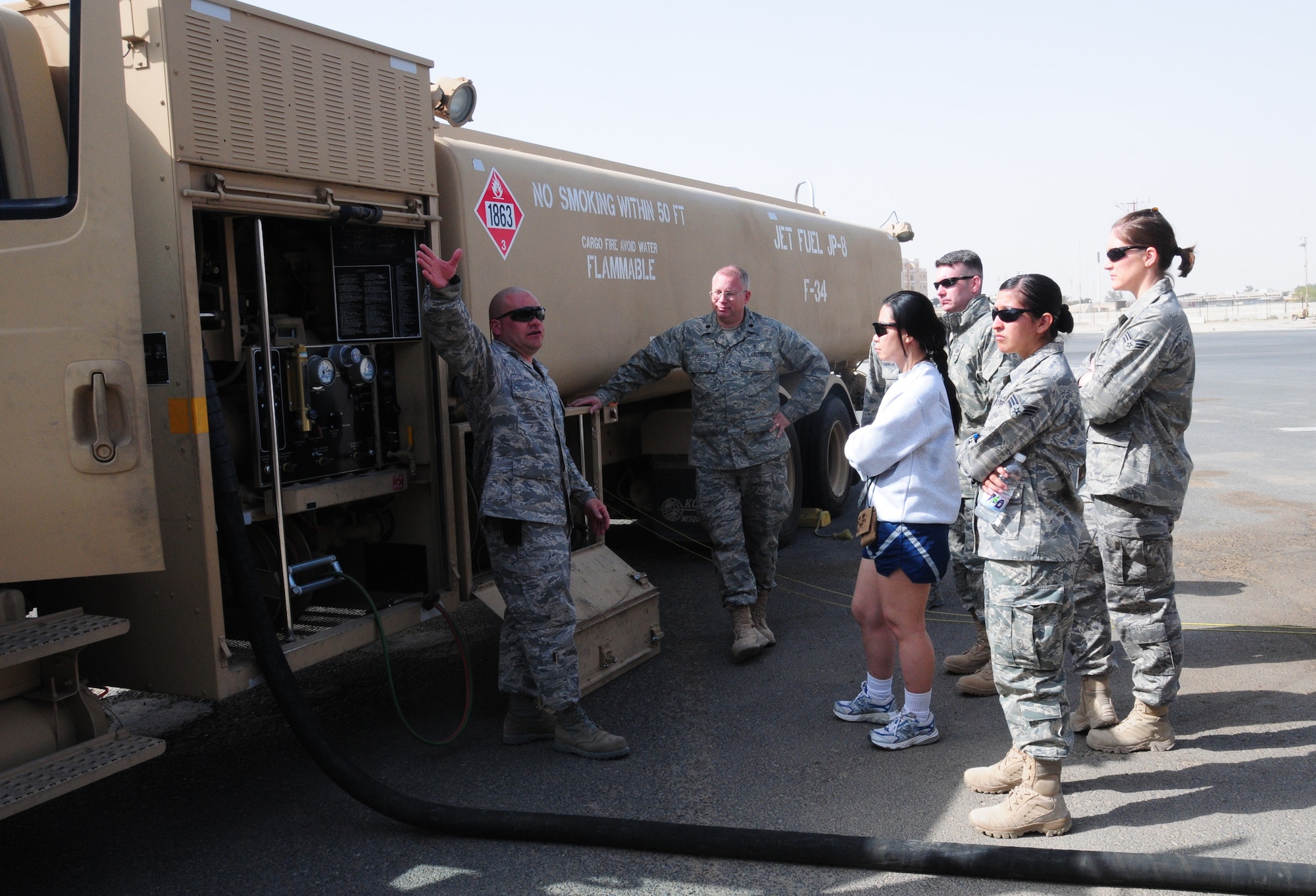 U.S. Air Force Tech. Sgt. Joseph Pugh, 386th Expeditionary Logistics Readiness Squadron petroleum, oil and lubricants distribution supervisor, explains the petrolium, oil and lubricants mission to members of the 386th Air Expeditionary Wing during the Quarry Open House Jan. 30, 2010 at an air base in Southwest Asia.  (U.S. Air Force photo by Staff Sgt. Lakisha A. Croley/Released)