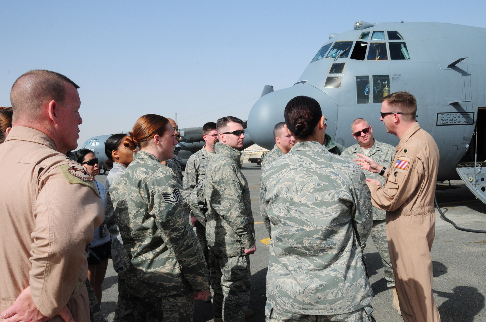 U.S. Air Force Lt. Col. Kyle Forrer, 43rd Expeditionary Electronic Combat Squadron commander, talks to 386th Air Expeditionary Wing members about the EC-130 Jan. 30, 2010 during the Quarry Open House at an air base in Southwest Asia. (U.S. Air Force photo by Staff Sgt. Lakisha A. Croley/Released)