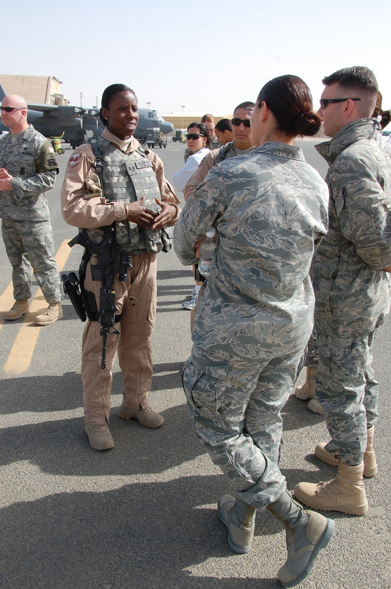 Staff Sgt. Michelle Miller-Faruq, 386th Expeditionary Security Forces Squadron, explains her job to other Airmen assigned to the 386th Air Expeditionary Wing Jan. 30, 2010 during the Quarry Open House at an air base in Southwest Asia. (U.S. Air Force photo by Staff Sgt. Lindsey Maurice/Released)