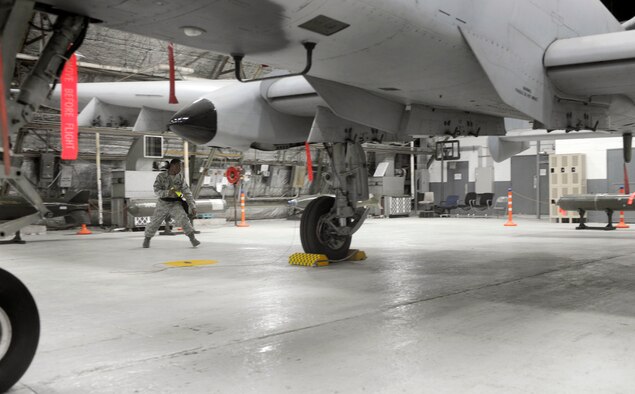 Senior Airman Brandon Wallace completes final checks of his teams aircraft, an A-10, in the fourth quarter weapons load crew competition at Osan Air Base, Republic of Korea, Jan. 29. SrA Wallace is a weapons load team member from the 51st Aircraft Maintenance Squadron. ( U.S. Air Force photo/ Senior Airman Stephenie Wade)