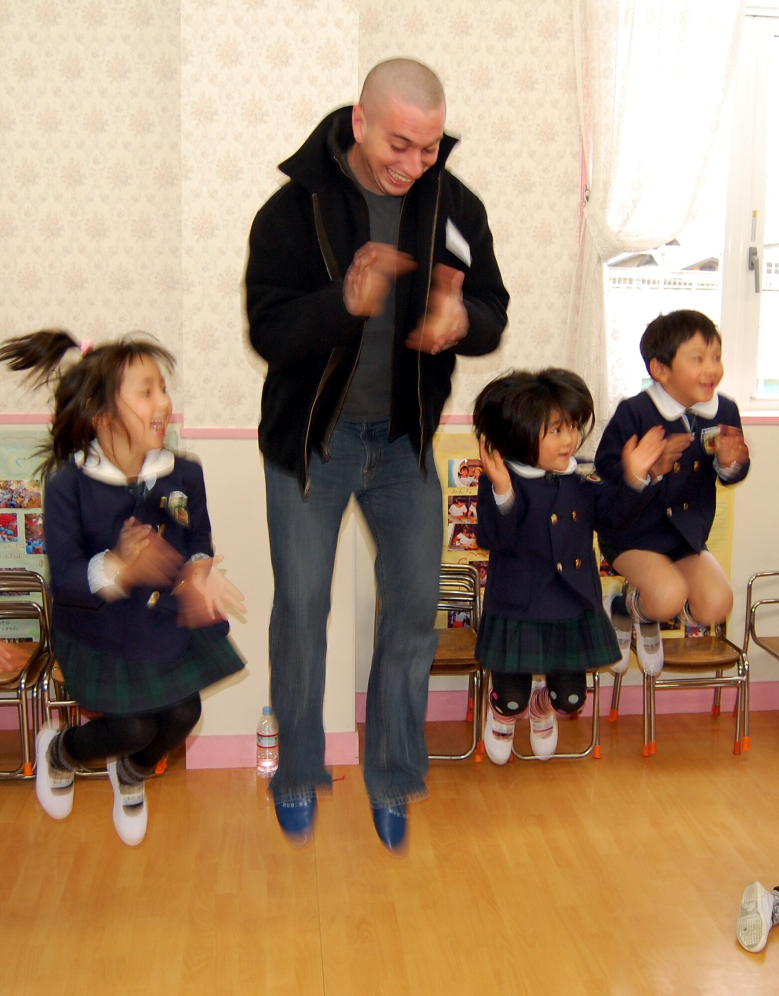 Airman 1st Class Andrew Augustine participates in a Japanese children's song while visiting Runbini Kindergarten near Hyakuri Air Base Feb. 1. A dozen Kadena Airmen visited the school while operating from the Japanese air base. (U.S. Air Force photo / 1st Lt. Bryan Bouchard)