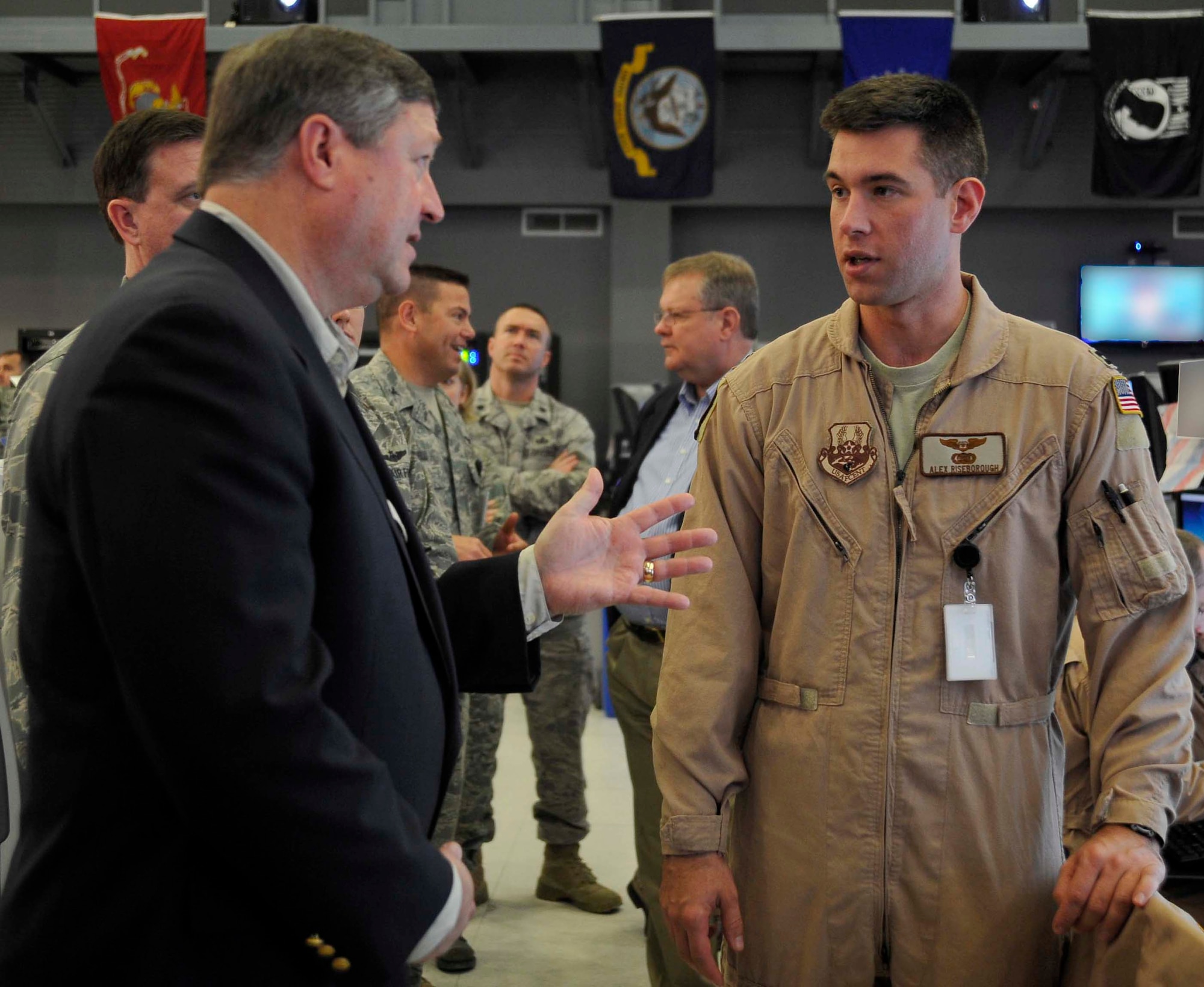 Secretary of the Air Force Michael Donley speaks to U.S. Air Force Capt. Alexander Riseborough,a 609th Air and Space Operations Center liasion officer, about flying operations as he walks through the Combined Air and Space Operation Center, Jan. 29, 2010, in Southwest Asia. (U.S. Air Force photo/ STAFF Sgt Angelita Lawrence/released)