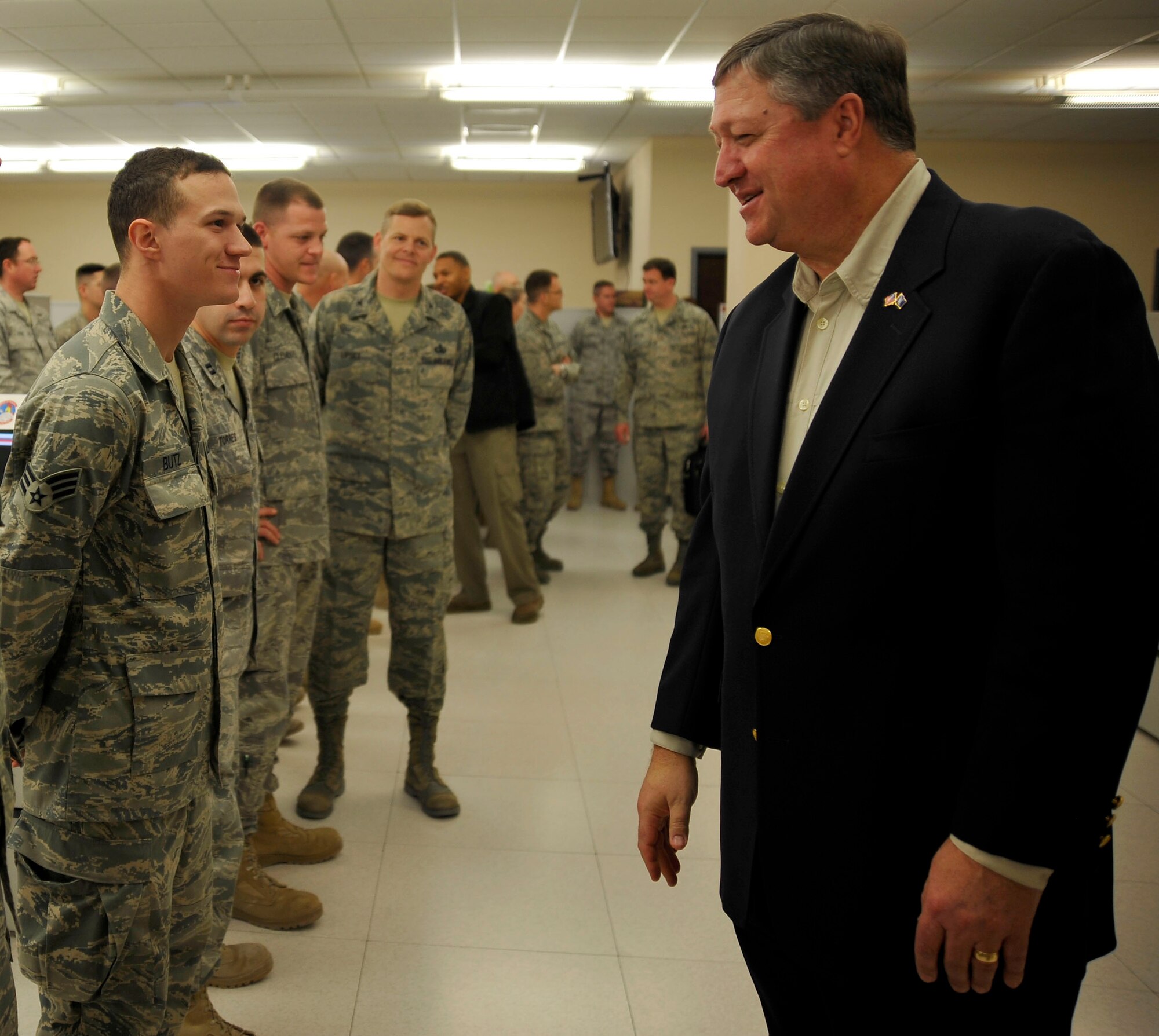 U.S. Air Force Senior Airman Michael A. Butz, Combined Air and Space Operations Center A63 radio-frequency transmissions apprentice, greets Secretary of the Air Force Michael Donley, inside the CAOC Jan. 29, 2010, in Southwest Asia. Airman Butz hails from Tinker Air Force Base, Okla. (U.S. Air Force photo/Staff Sgt Angelita Lawrence/released)
