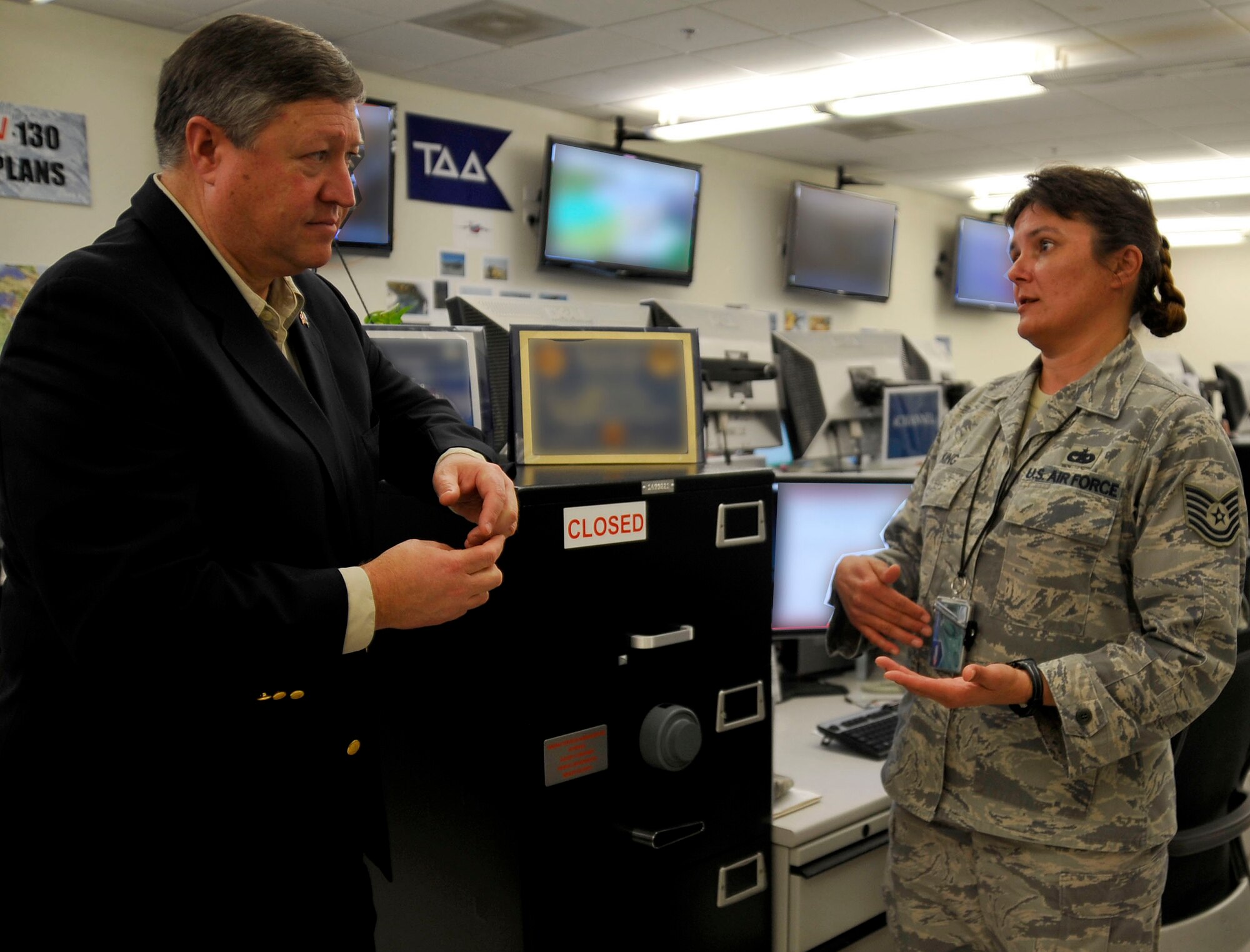 U.S. Air Force Tech Sgt. Adonna King, 609th Air and Space Operations Center theater-express program manager, briefs Secretary of the Air Force Michael Donley, about cargo transportation in Afghanistan and Iraq during his visit to the Combined Air and Space Operations Center, Jan. 29, 2010, in Southwest Asia. (U.S. Air Force photo/Staff Sgt. Angelita Lawrence/released)