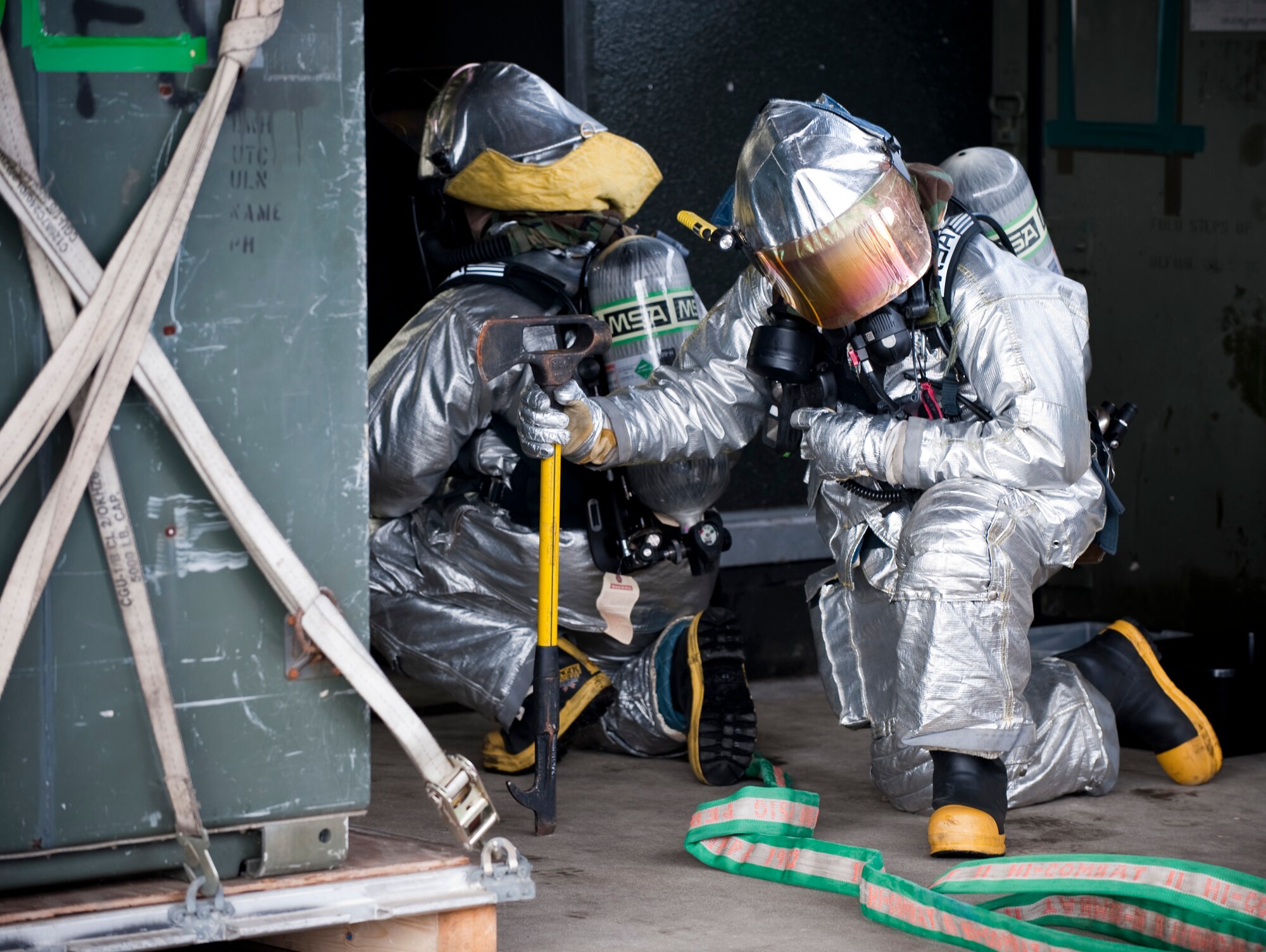 MISAWA AIR BASE, Japan -- Two 35th Civil Engineer Squadron firemen wait to enter a simulated burning building on the flightline during an operational readiness exercise Feb. 1. Scenarios such as this help hone the skills of firefighters. (U.S. Air Force photo/Staff Sgt. Samuel Morse)