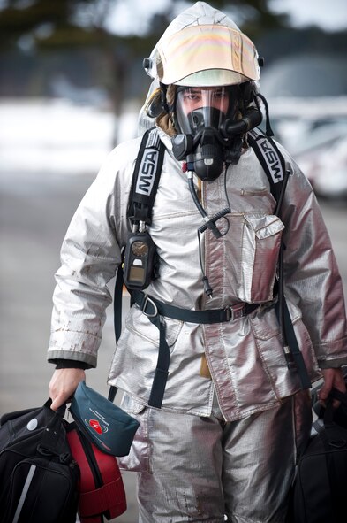 MISAWA AIR BASE, Japan -- Senior Airman Marvin Beacham, 35th Civil Engineer Squadron fire protection driver and operator, carries medical bags to a triage point during an operational readiness exercise Feb. 1. The 35th CES fire department responded to a simulated fire on the flightline to test their response time and ability to tend to the injured. (U.S. Air Force photo/Staff Sgt. Samuel Morse)