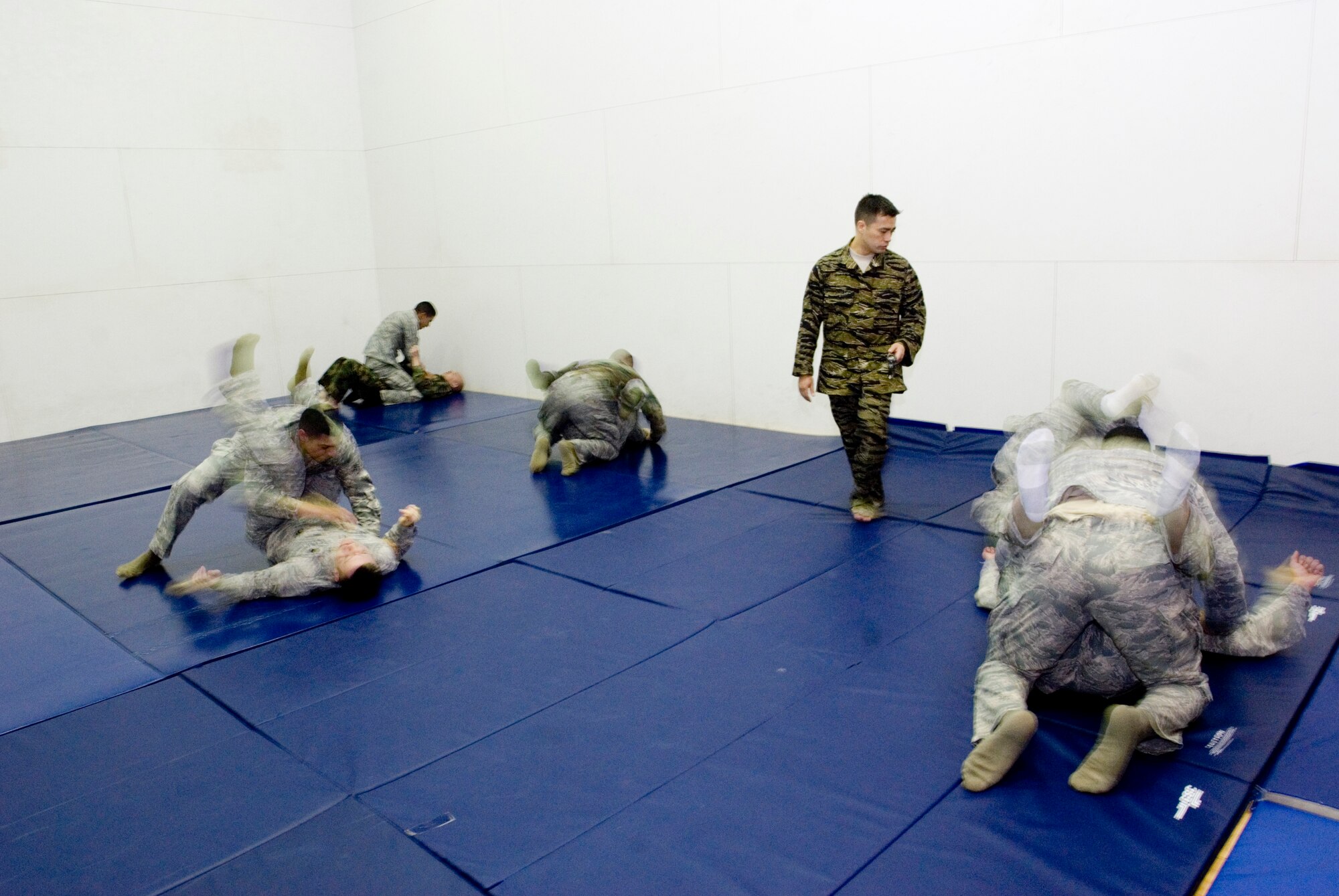 KUNSAN AIR BASE, Republic of Korea -- Staff Sgt. Tony Fancher, 8th Operations Support Squadron survival evasion resistance and escape specialist, coaches 8th Security Forces members through combatives training Jan. 27. The training, which is based off the Army's Modern Army Combatives Program, refreshes the SFS members basic ground fighting techniques. (U.S. Air Force photo/Senior Airman Jonathan Steffen)