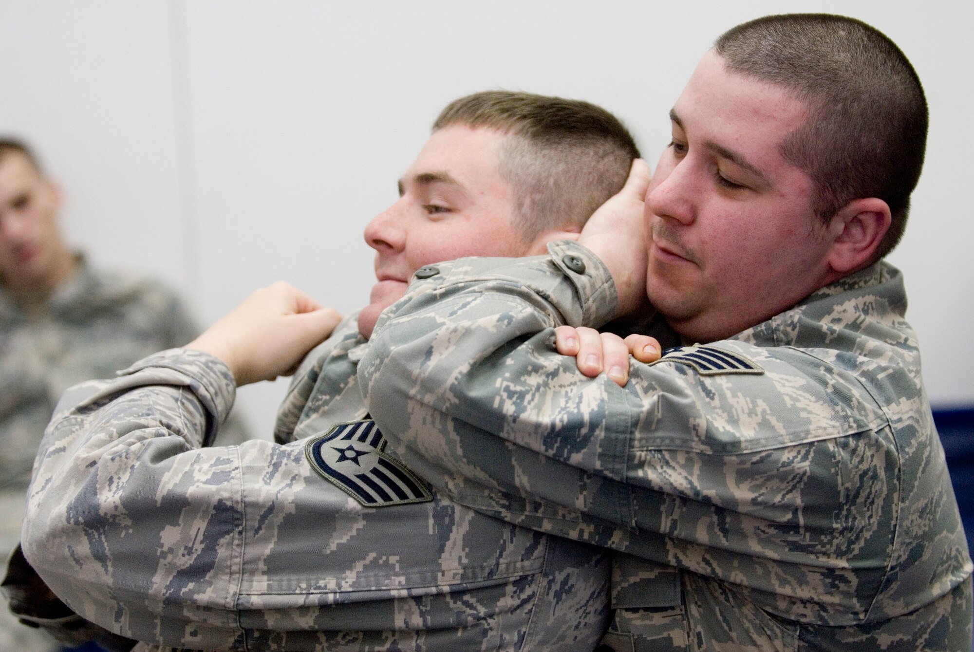 KUNSAN AIR BASE, Republic of Korea -- Staff Sgt. Walter Mobley, chokes out Staff Sgt. Dustin Wells, both from th 8th Security Forces Squadron, during combatives training Jan. 27. The SFS members complete 10 hours of combatives training based off the Army's Modern Army Combatives Program which focuses on basic ground fighting techniques. (U.S. Air Force photo/Senior Airman Jonathan Steffen)