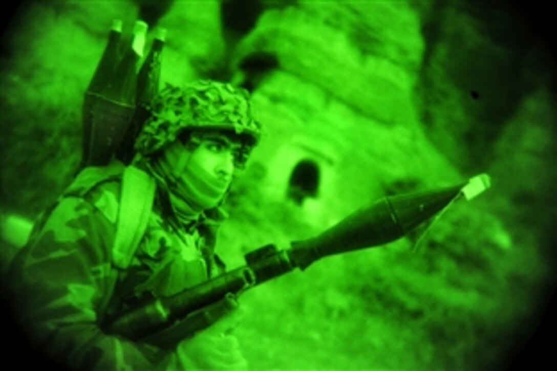 As seen through a night-vision device, an Afghan soldier provides security as U.S. soldiers search multiple caves for weapons during Operation Wawraa Tufaan in Zanbar province, Afghanistan, Jan. 31, 2010. The U.S. soldiers are assigned to the 25th Infantry Division's Company D, 1st Battalion, 501st Infantry Regiment, 4th Brigade Combat Team.