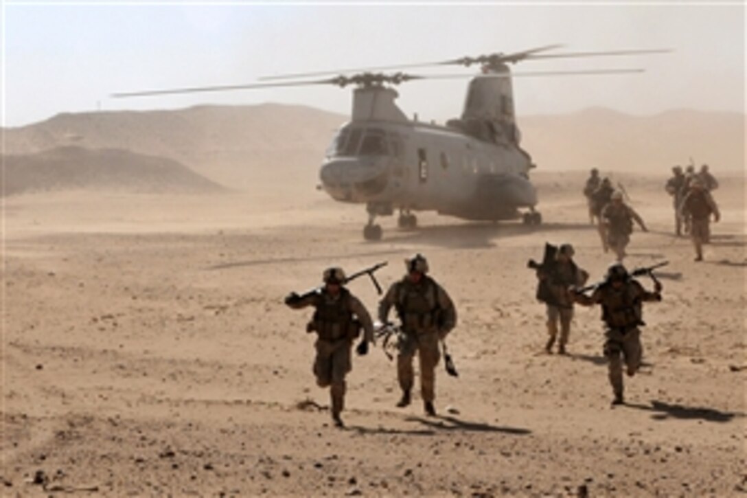 U.S. Marines leave a CH-47 Sea Knight as they prepare to engage a command and control cell as part of their final exercise at Udari Range, Kuwait, Jan. 23, 2010. The Marines, assigned to the 11th Marine Expeditionary Unit, cleared the cell in under an hour. The range enables battalion sized live-fire scenarios for all warfighters to train with the maximum amount of realism in a controlled environment. 