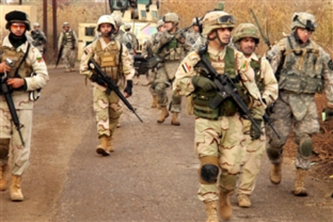 Iraqi soldiers march ahead of U.S. soldiers during their first combined patrol in Taji, Iraq, Jan. 30, 2010. The U.S. soldiers are assigned to the 2nd Infantry Division's 2nd Squadron, 1st Cavalry Regiment, 4th Brigade Combat Team.