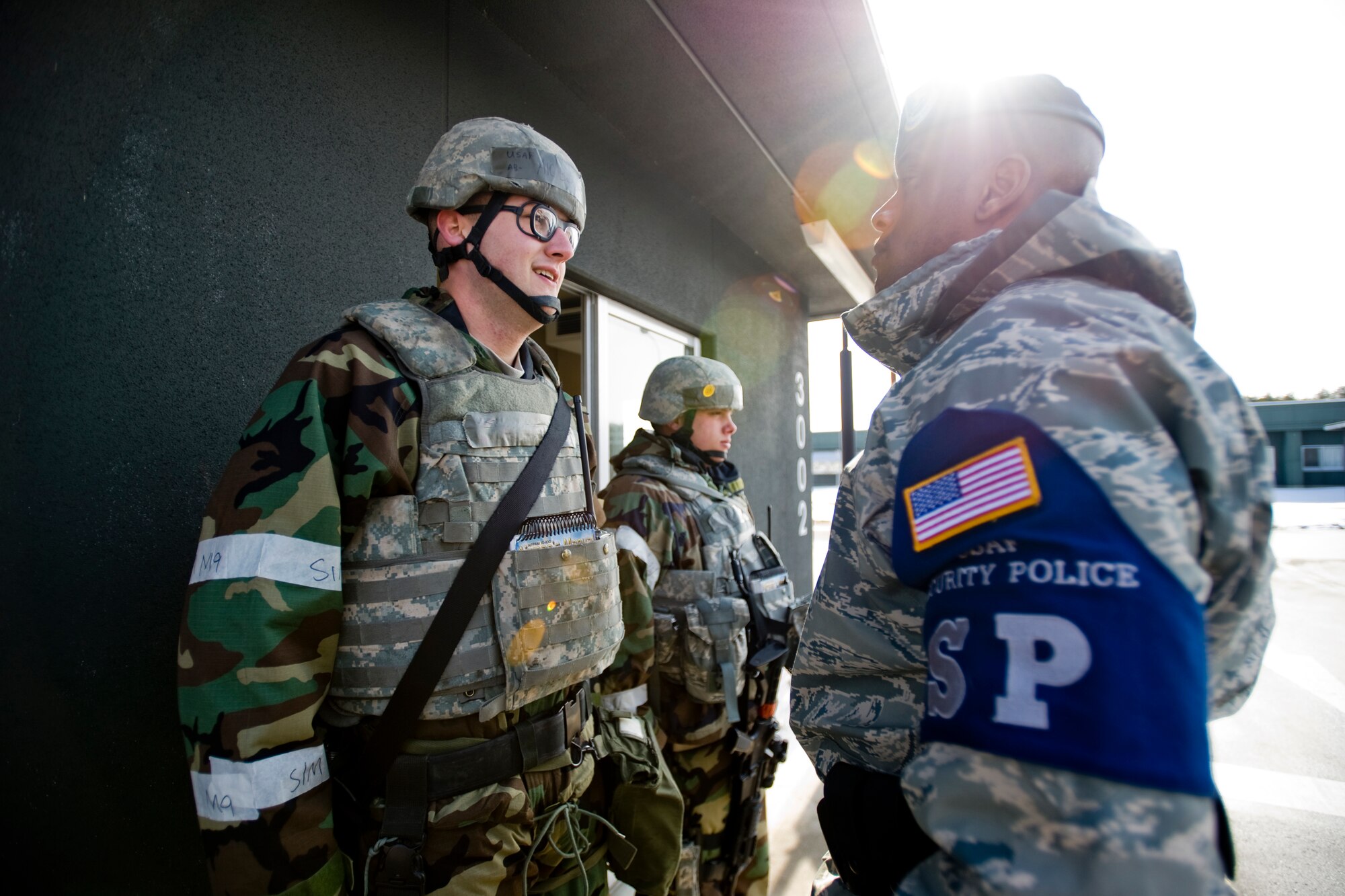 MISAWA AIR BASE, Japan -- Airman 1st Class Benjamin Baird, 35th Security Forces Squadron entry controller, briefs Tech. Sgt. Samaki Tonge, 35th SFS Bravo flight chief, during a post visit Feb. 2 at a flightline entry-control point. During post visits, flight chiefs check on the well-being of their Airmen and receive status updates on events that occurred at the location. (U.S. Air Force photo/Senior Airman Jamal D. Sutter)