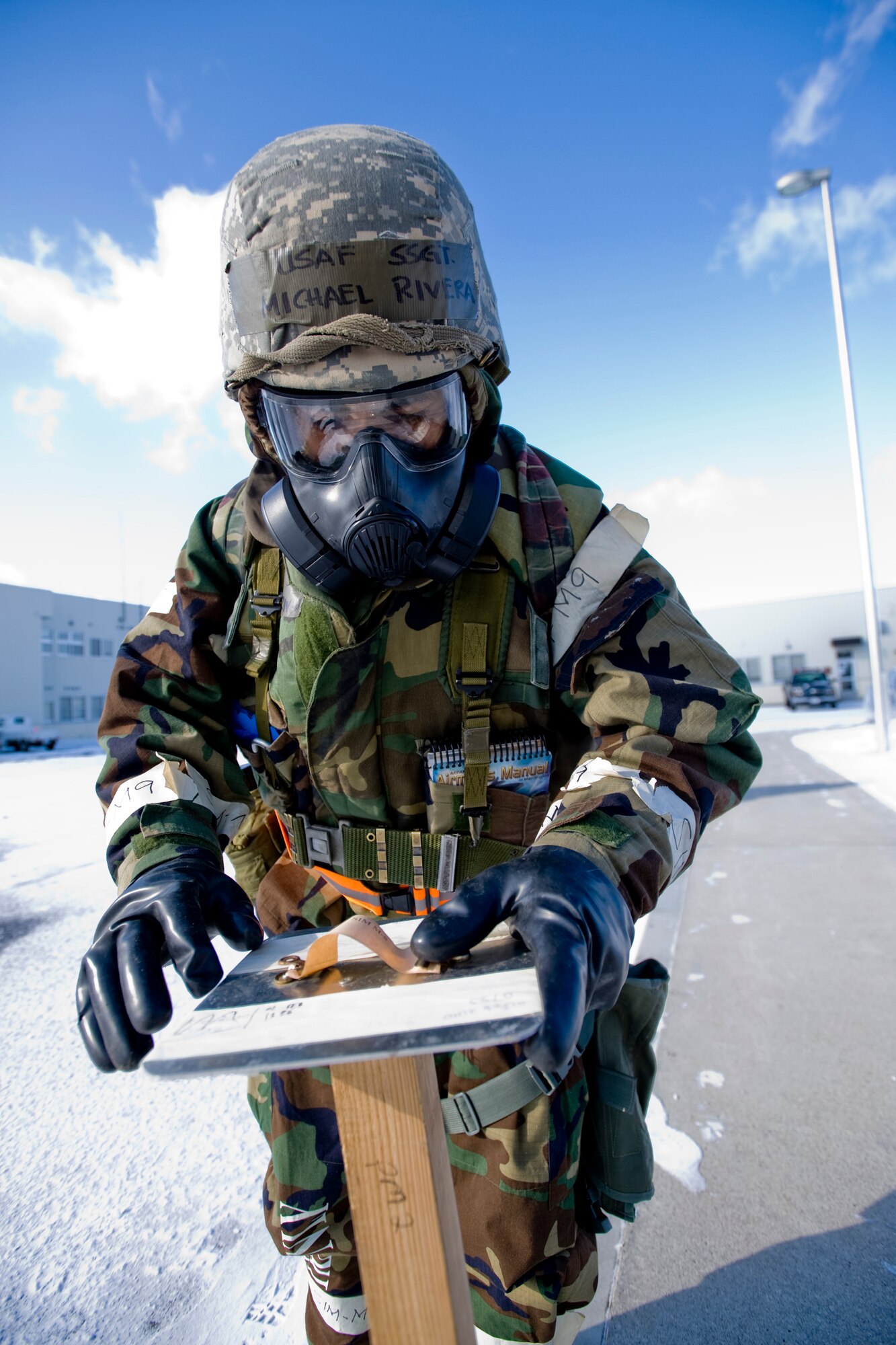 MISAWA AIR BASE, Japan -- Staff Sgt. Michael Rivera, 35th Civil Engineer Squadron water and fuels maintenance technician, inspects M8 chemical agent detection paper at the civil engineer compound Feb. 3 during an operational readiness exercise. Sergeant Rivera is part of a 35th CES security team that conducts post-attack reconnaissance and security sweeps after an attack. (U.S. Air Force photo/Senior Airman Jamal D. Sutter)