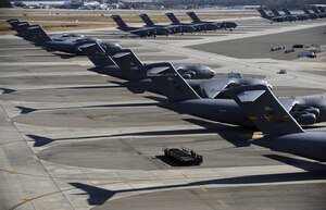 C-17 Globemaster III aircraft from Joint Base Charleston, Elmendorf Air Force Base, Alaska, McChord AFB, Wash., and Joint Base Pearl Harbor Hickam, Hawaii, await missions to Haiti on the flightline here Jan. 27. As of Feb. 2, Charleston has served as the C-17 stage for more than 240 missions to Haiti, managing a vast number of aircrews supporting Operation Unified Response. (U.S. Air Force photo/Staff Sgt. Eric Harris)