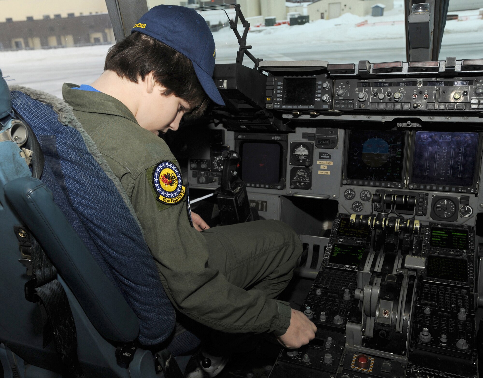 ELMENDORF AIR FORCE BASE, Alaska -- Brendan Thompson, 19 Fighter Squadron's Pilot for a Day and Make-A-Wish recipient, touches switches on a control panel in a C-17 Globemaster III Jan 29. Brendan was diagnosed with Aplastic Anemia, a rare bone marrow cancer, and is currently receiving treatment. (U.S. Air Force photo/ Airman 1st Class Kristin High)