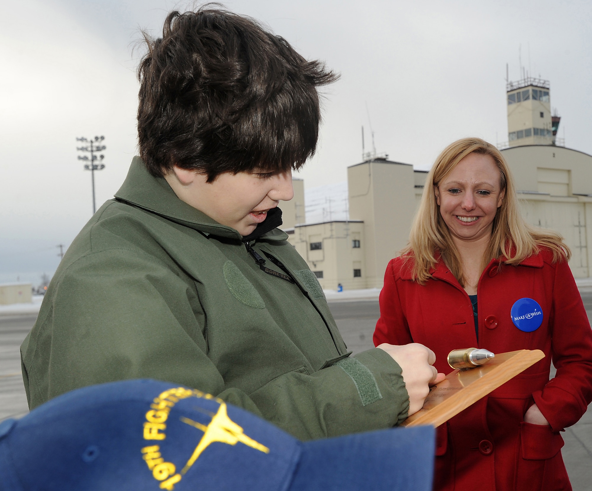 ELMENDORF AIR FORCE BASE, Alaska -- Brendan Thompson, 19th Fighter Squadron's Pilot for a Day and Make-A-Wish recipient, is presented a plaque by F-15 Weapons Maintainers commemorating his flight Jan 29. Elizabeth Ross, 3rd Civil Engineer Squadron and Make-A-Wish volunteer accompanied him and his family during the day. Brendan was diagnosed with Aplastic Anemia, a rare bone marrow cancer, and is currently receiving treatment. (U.S. Air Force photo/ Airman 1st Class Kristin High)