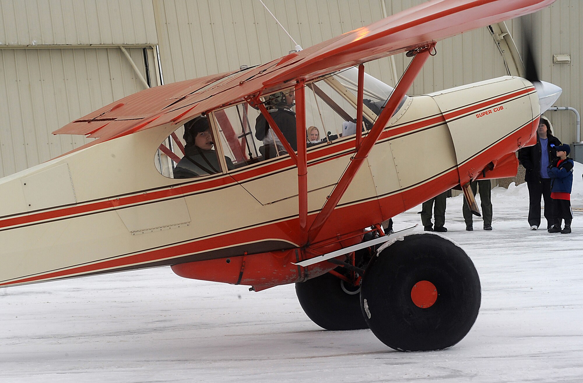 ELMENDORF AIR FORCE BASE, Alaska -- Brendan Thompson, 19 Fighter Squadron's Pilot for a Day and Make-A-Wish recipient, looks back before his Super Cub Flight piloted by 19FS Honorary Commander Leah Sommer takes off Jan 29. Brendan was diagnosed with Aplastic Anemia, a rare bone marrow cancer, and is currently receiving treatment. (U.S. Air Force photo/ Airman 1st Class Kristin High)