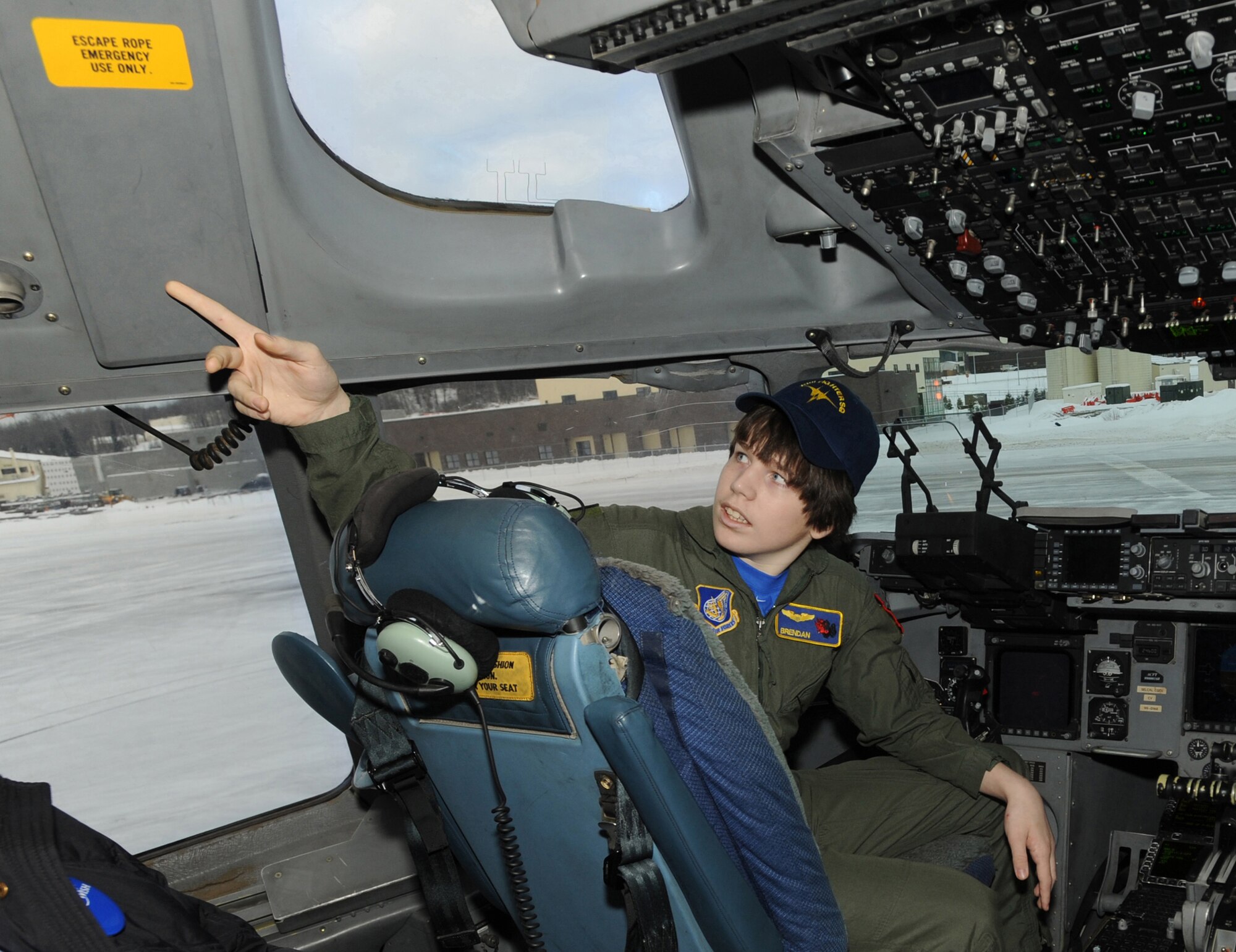 ELMENDORF AIR FORCE BASE, Alaska -- Brendan Thompson, 19 Fighter Squadron's Pilot for a Day and Make-A-Wish recipient, asks about the escape hatch in a C-17 Globemaster III Jan 29. Brendan was diagnosed with Aplastic Anemia, a rare bone marrow cancer, and is currently receiving treatment. (U.S. Air Force photo/ Airman 1st Class Kristin High)