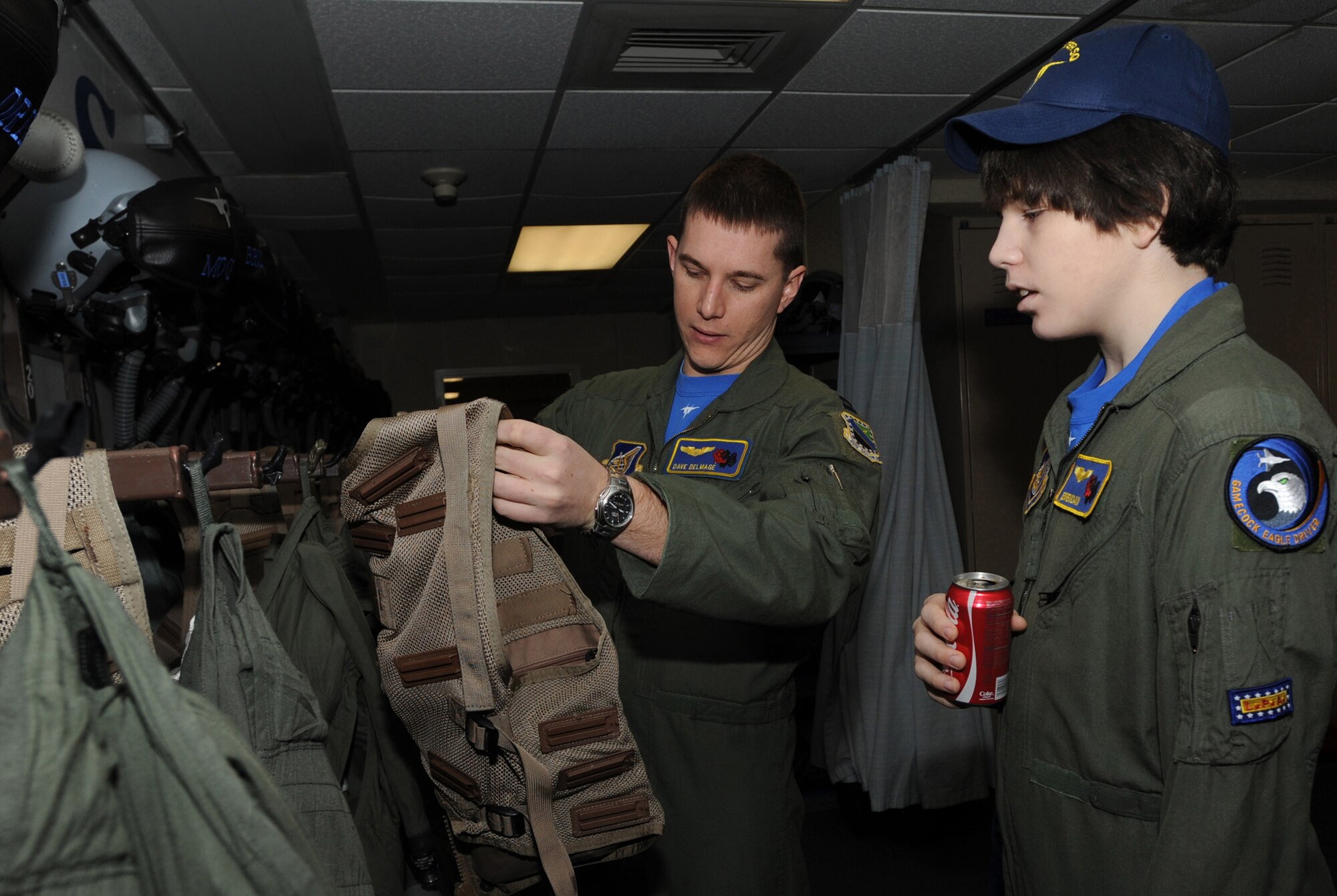 ELMENDORF AIR FORCE BASE, Alaska -- Capt. Dave Delmage, 19th Fighter Squadron shows Brendan Thompson, Pilot for a Day and Make-A-Wish recipient the F-15 survival vest Jan. 29. Brendan was diagnosed with Aplastic Anemia, a rare bone marrow cancer, and is currently receiving treatment. (U.S. Air Force photo/ Airman 1st Class Kristin High)