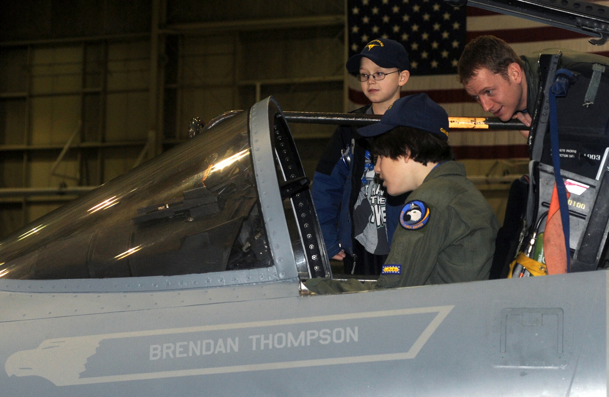 ELMENDORF AIR FORCE BASE, Alaska -- Brendan Thompson, 19 Fighter Squadron's Pilot for a Day and Make-A-Wish recipient, sits in his personalized F-15C as Capt. Craig Van Beusekom explains the controls to him and his younger brother, Joshua Jan. 29. Brendan was diagnosed with Aplastic Anemia, a rare bone marrow cancer, and is currently receiving treatment. (U.S. Air Force photo/ Airman 1st Class Kristin High)