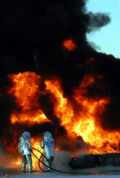 Firefighters from the Japan Air Self Defense Force work to extinguish a controlled blaze Feb. 3 at Hyakuri Air Base. Two Kadena firefighters are working alongside their JASDF counterparts to exchange information and learn how the Japanese perform fire protection duties. (U.S. Air Force photo / 1st Lt. Bryan Bouchard)