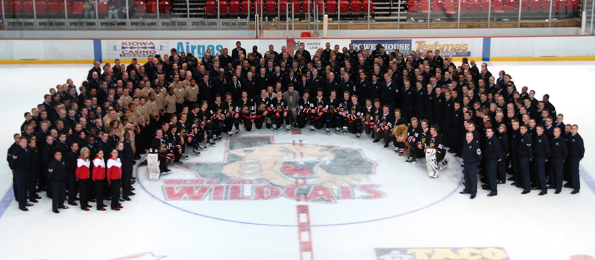 Sheppard attendees pose with the Wichita Falls Wildcats Hockey Team and coaches at the Wichita Falls Wildcats Military Appreciation Game Jan. 30 at the Kay Yeager Coliseum. (U.S. Air Force photo/Mike Litteken)