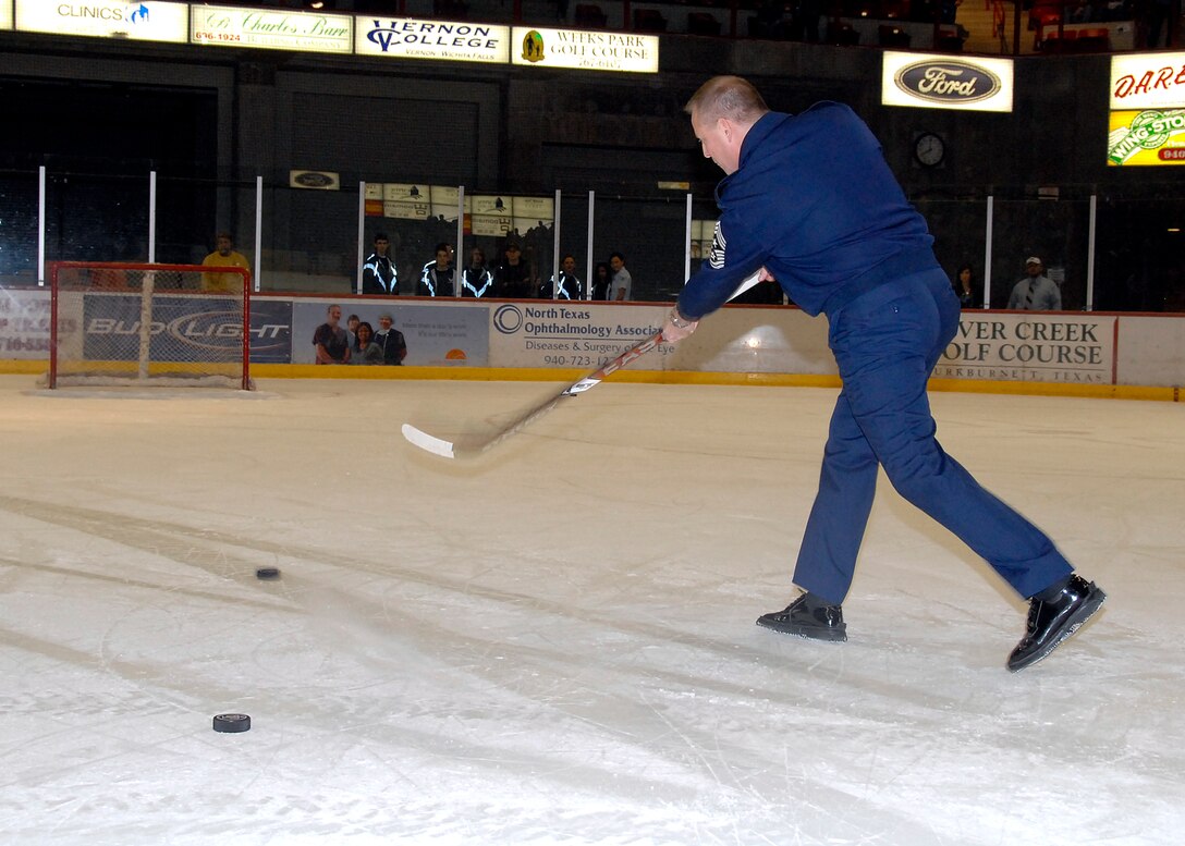 Chief Master Sgt. Kenneth Sallinger, 82nd Training Wing command chief, shoots for a goal to try to win the crowd a free Whataburgers at the Wichita Falls Wildcats Military Appreciation Game Jan. 30 at the Kay Yeager Coliseum. (U.S. Air Force photo/Mike Litteken)