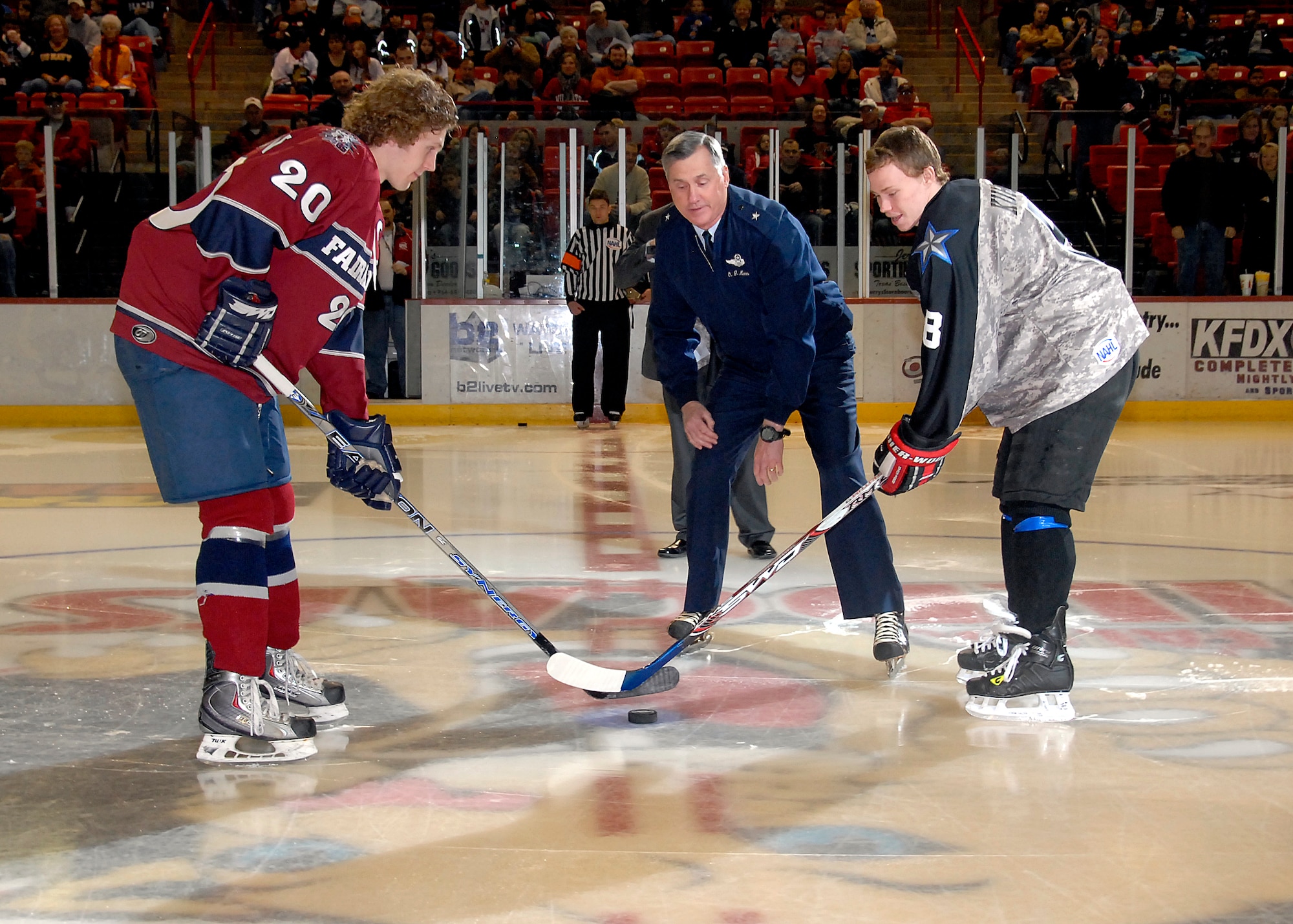 Brig. Gen. O.G. Mannon, 82nd Training Wing commander, drops the puck to start the game Jan. 30 at the beginning of the Wichita Falls Wildcats Military Appreciation Game at the Kay Yeager Coliseum. (U.S. Air Force photo/Mike Litteken)