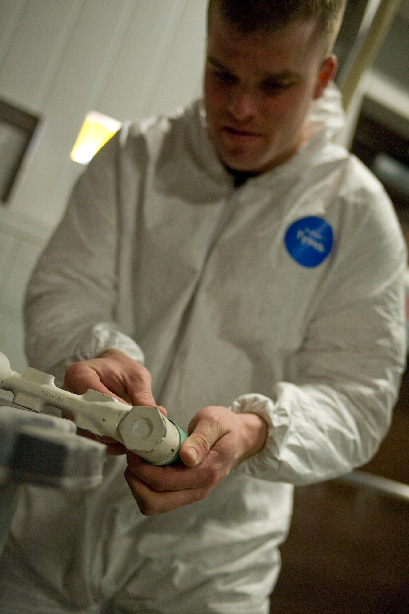 ELLSWORTH AIR FORCE BASE S.D.-- Airman 1st Class Joel Marbury, 28th Maintenance Squadron aircraft structural maintenance apprentice, wraps blast tape on a brake swivel before spraying, Feb. 2. The blast tape is used to prevent the grooves or threads on certain equipment from warping during spraying. (U.S. Air Force photo/Airman 1st Class Corey Hook)