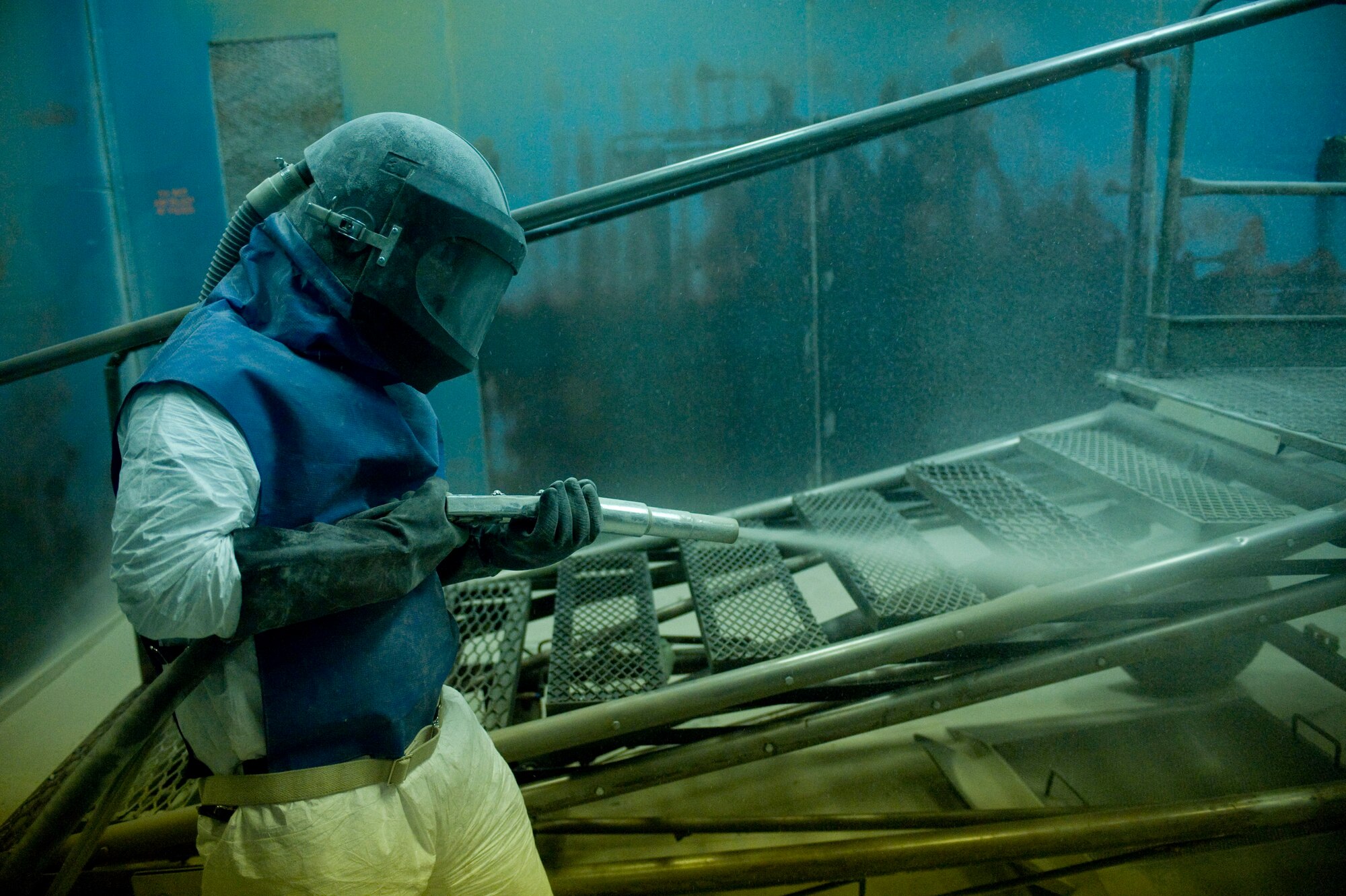 ELLSWORTH AIR FORCE BASE S.D.-- Airman 1st Class Joel Marbury, 28th Maintenance Squadron aircraft structural maintenance apprentice, sprays a B-1B Lancer stand to strip old paint, Feb. 2. The structural maintenance shop has a corrosion prevention program where they sand, blast and paint equipment on a daily basis. (U.S. Air Force photo/Airman 1st Class Corey Hook)