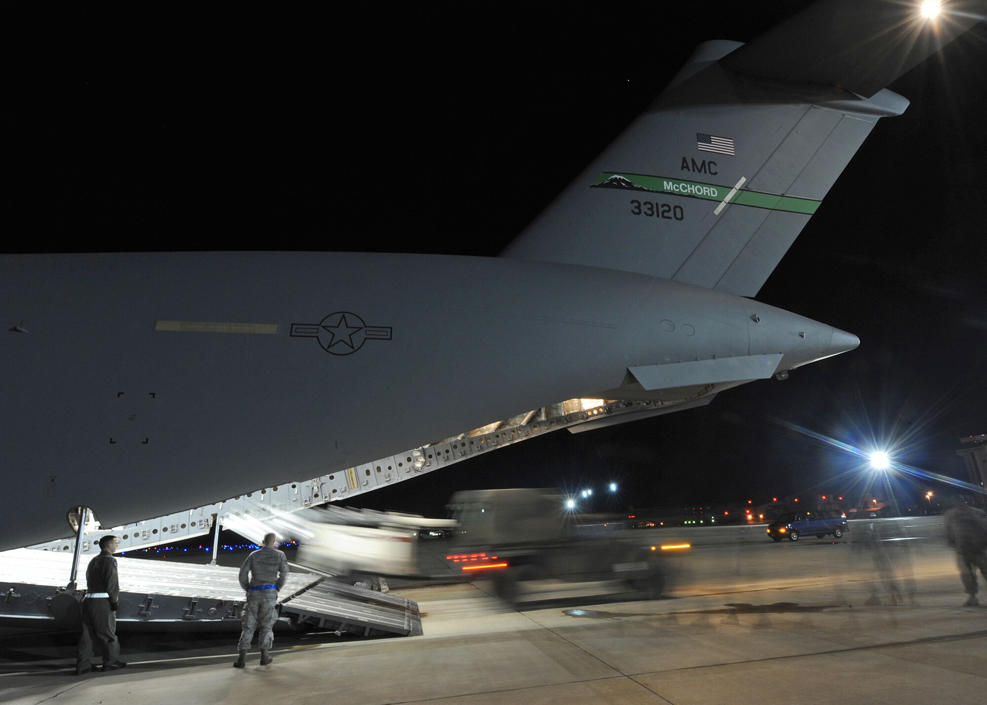 A military multipurpose vehicle backs a high-powered light fixture into the bay of a C-17 Globemaster III in support Operation Unified Response Jan. 22, 2010, at Langley Air Force Base, Va. Langley AFB Airmen and Army members from Fort Eustis, Va., loaded the aircraft. (U.S. Air Force photo/ Airman Rebecca Montez)