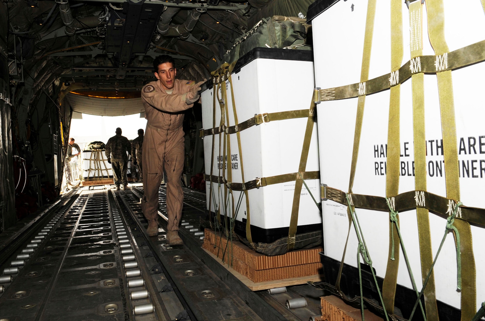Tech. Sgt. Jay Krahl helps upload containerized delivery systems onto a C-130J Super Hercules Jan. 29, 2010, at Kandahar Airfield, Afghanistan. Sergeant Krahl is a 772nd Expeditionary Airlift Squadron loadmaster. (U.S. Air Force photo/Senior Airman Nancy Hooks)