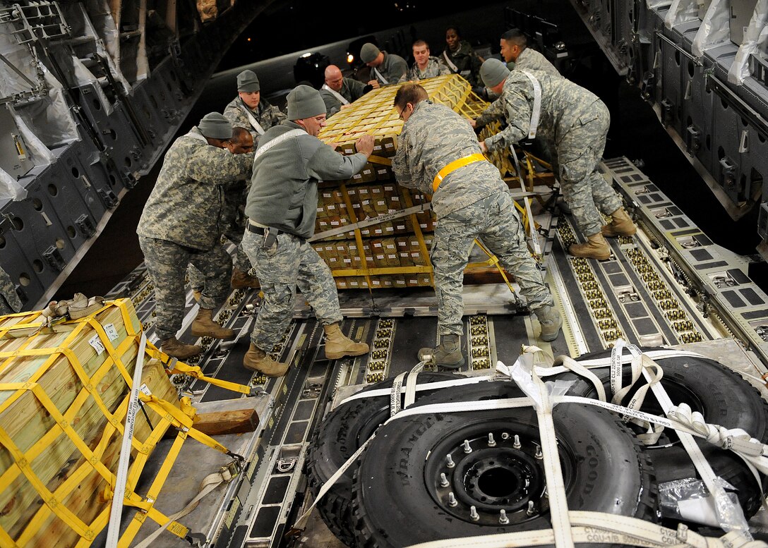 Army and Air Force personnel work together to load supplies into a C-17 Globemaster III Jan. 22, 2010, at Langley Air Force Base, Va., in support Operation Unified Response. (U.S. Air Force photo/ Airman Rebecca Montez)