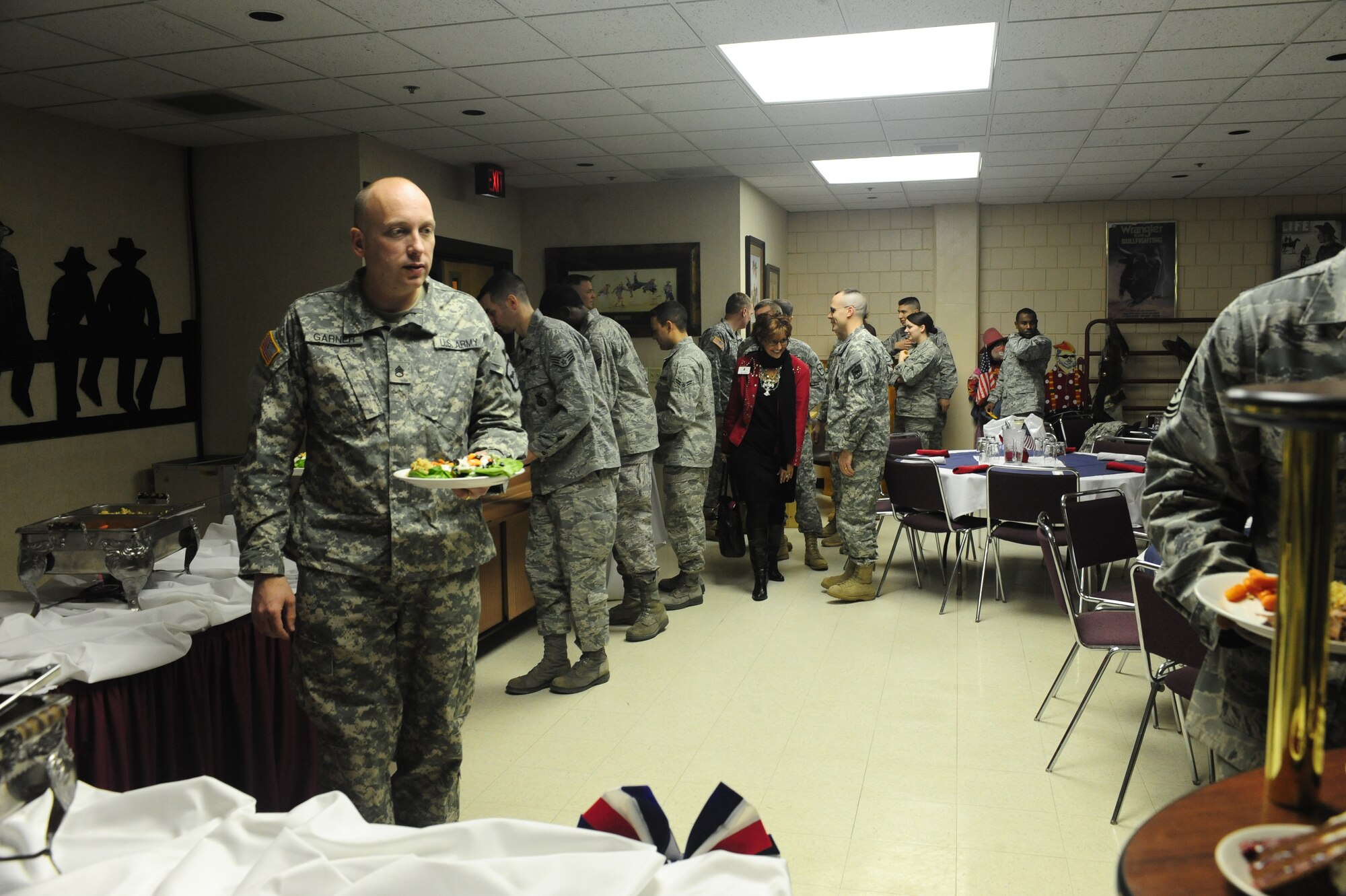 ELLSWORTH AIR FORCE BASE, S.D. -- Ellsworth Airmen and members of the South Dakota Army National Guard, walk through a buffet line during a military appreciation luncheon, Feb 2.  The Black Hills Stockshow Foundation committee showed their appreciation for members of the military by providing a lunch in their honor. (U.S. Air Force photo/Airman 1st Class Anthony Sanchelli)


