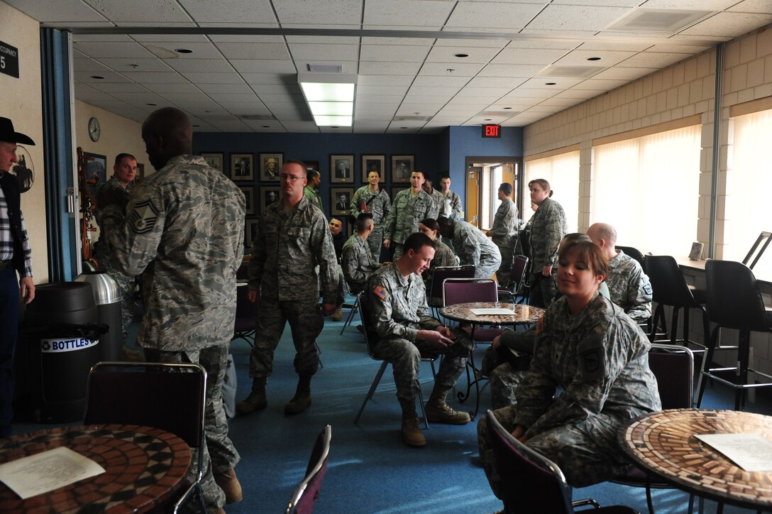 ELLSWORTH AIR FORCE BASE, S.D. -- Ellsworth Airmen and members of the South Dakota Army National Guard, congregate before being recognized during a military appreciation luncheon, Feb 2.  The Black Hills Stockshow Foundation committee showed their appreciation for the U.S. servicemembers by providing a lunch in their honor. (U.S. Air Force photo/Airman 1st Class Anthony Sanchelli)

