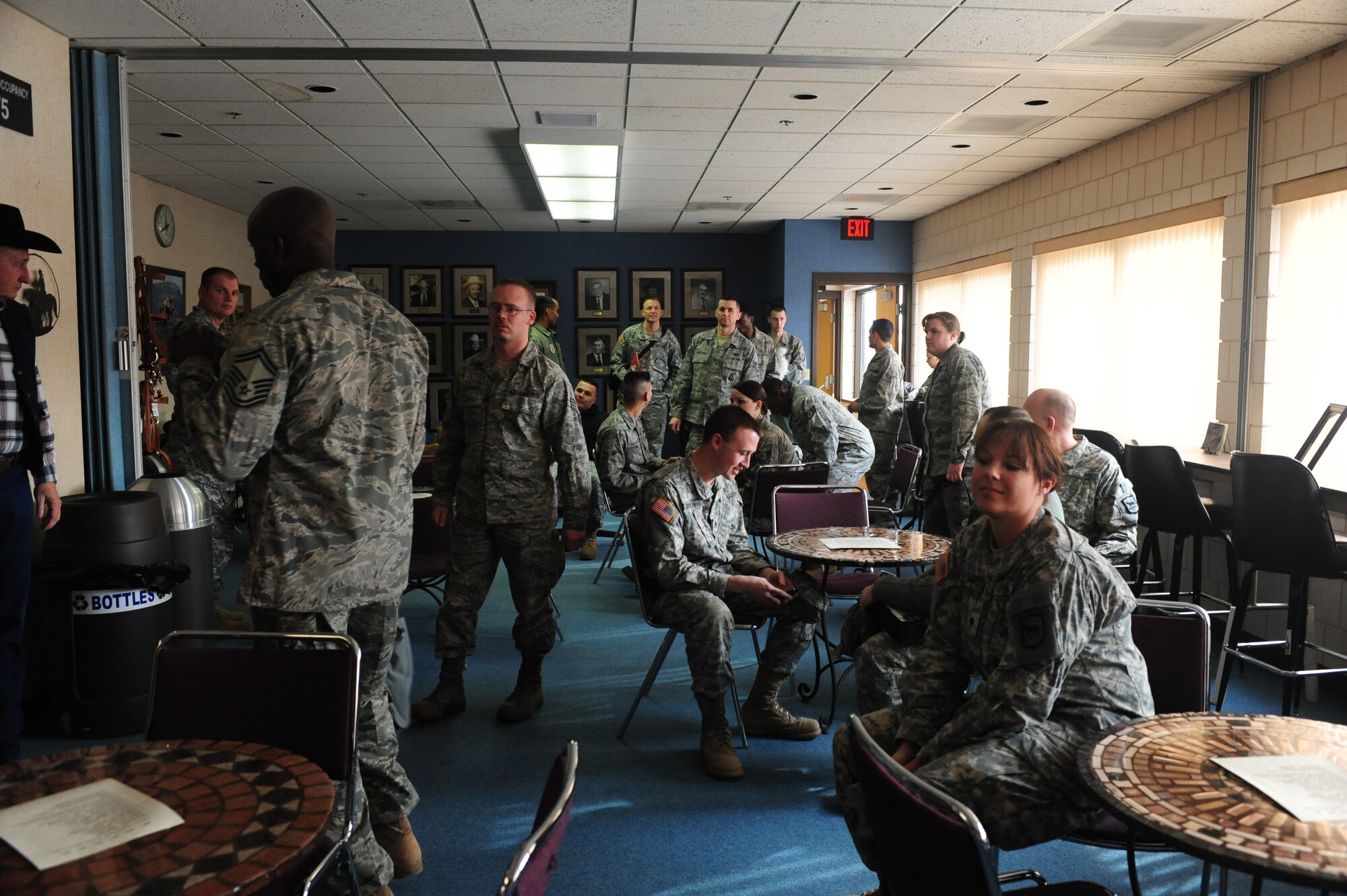 ELLSWORTH AIR FORCE BASE, S.D. -- Ellsworth Airmen and members of the South Dakota Army National Guard, congregate before being recognized during a military appreciation luncheon, Feb 2.  The Black Hills Stockshow Foundation committee showed their appreciation for the U.S. servicemembers by providing a lunch in their honor. (U.S. Air Force photo/Airman 1st Class Anthony Sanchelli)

