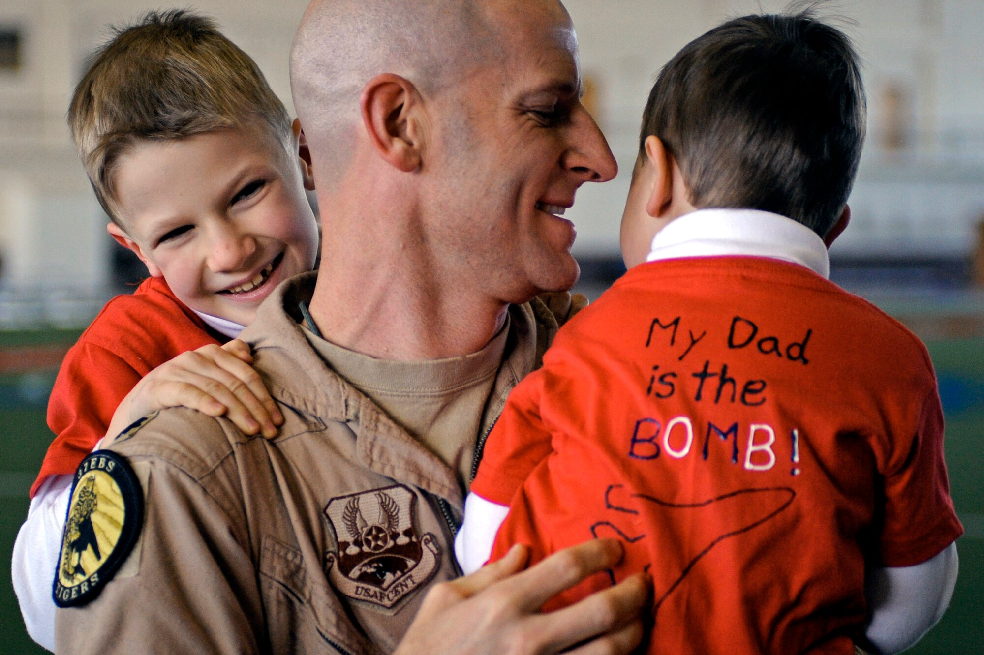 Lt. Col. Derek Leivestad holds his children after returning from a deployment to Southwest Asia Jan. 27, 2010, at Ellsworth Air Force Base, S.D. While deployed to Southwest Asia, Colonel Leivestad provided support to operations Iraqi Freedom and Enduring Freedom. Colonel Leivestad is a 37th Bomb Squadron B-1B Lancer pilot. (U.S. Air Force photo/Airman 1st Class Matthew Flynn)
