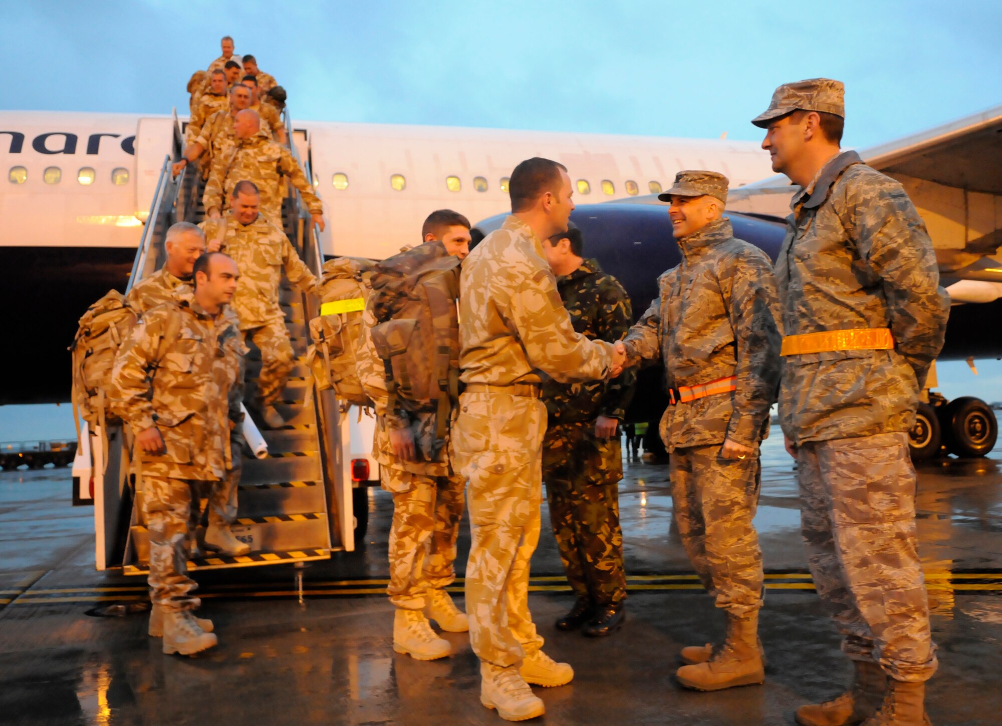 RAF MILDENHALL, England -- Col. Chad Manske, 100th Air Refueling Wing commander, shakes hands with members of the 27 Sqd RAF Regiment, RAF Honington as they return home from a six-month deployment in Afghanistan Feb. 2.  The returning aircraft landed at RAF Mildenhall instead of RAF Brize Norton, cutting off a five-hour bus ride to their home station.  (U.S. Air Force photo/Staff Sgt. Christopher L. Ingersoll)