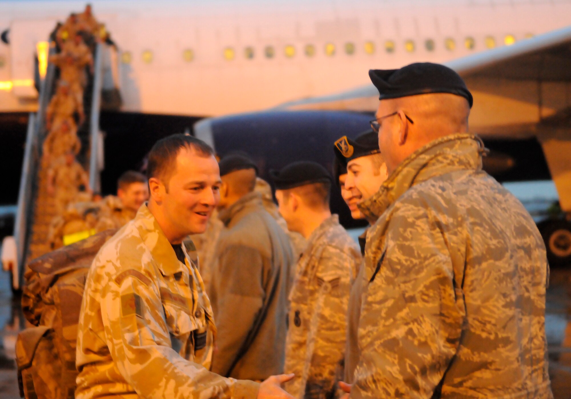 RAF MILDENHALL, England -- Several members of 27 Sqd RAF Regiment, RAF Honington, land at RAF Mildenhall Feb. 2, on their way back home from a six-month deployment in Afghanistan.  The 100th Security Forces Squadron lined up and welcomed them home as they got off the plane.  (U.S. Air Force photo/Staff Sgt. Christopher L. Ingersoll)