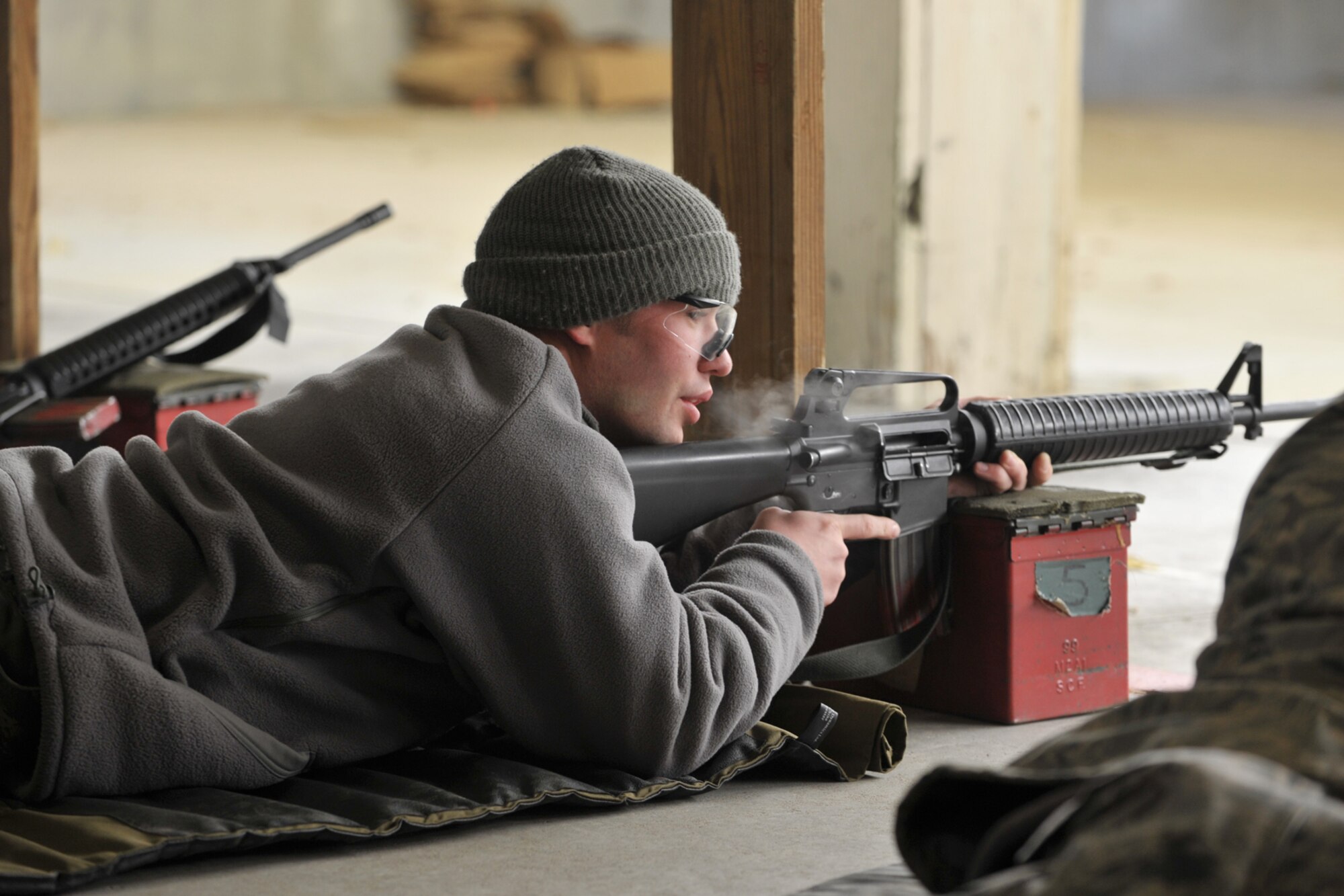 Airman 1st Class Joshua Krug's exhales during combat arms training at McConnell Air Force Base, Kan. Airman Krug and six of his fellow Reservists from the 931st Civil Engineer Squadron braved temperatures in the single digits while firing M-16A2 rifles at the base range in January. (U.S. Air Force photo/Master Sgt. Jason Schaap)