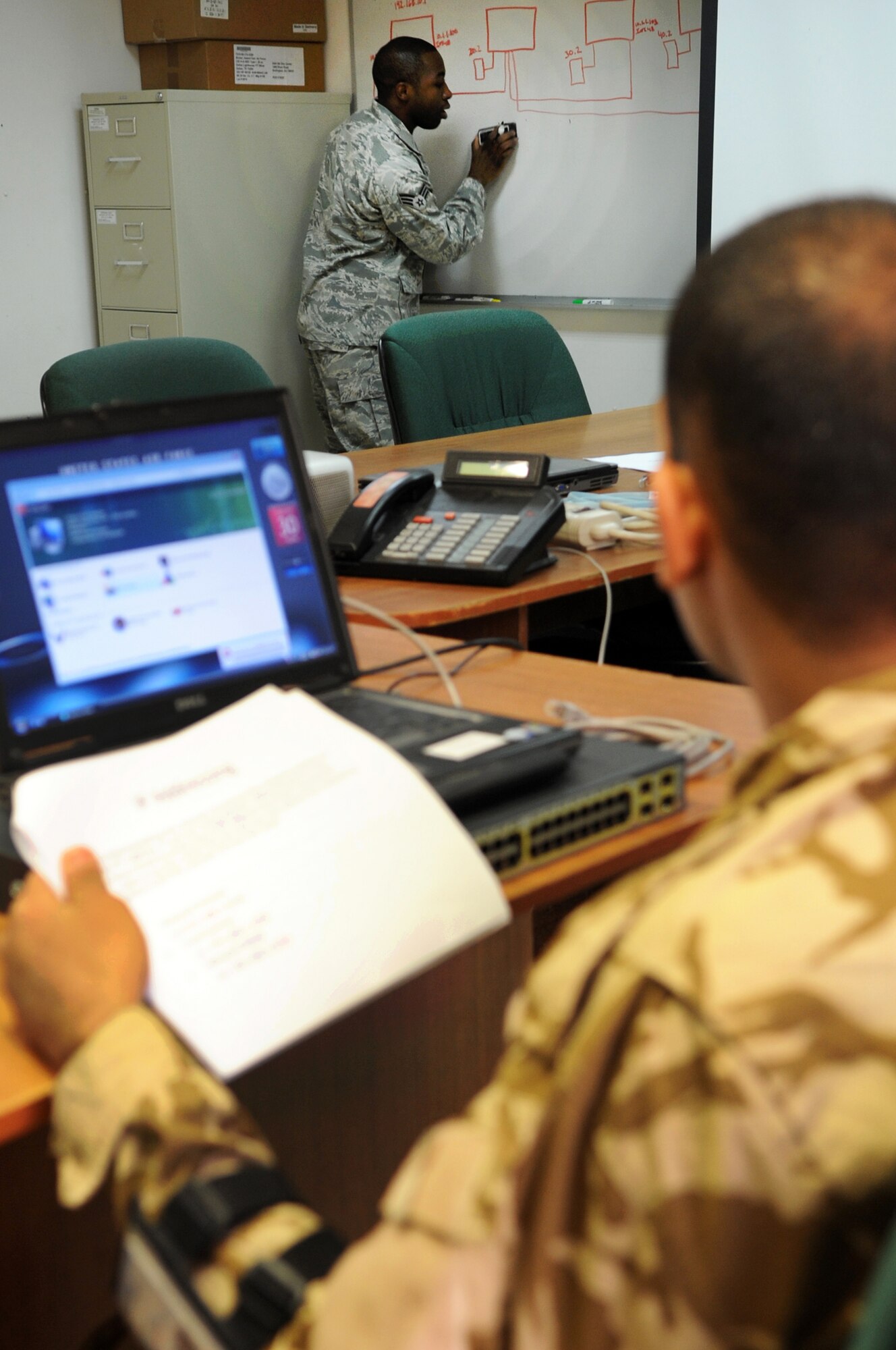 Senior Airman Andre Taylor teaches Iraqis basic configurations of communication methods Jan. 30, 2010, at Kirkuk Air Base, Iraq. Airman Taylor is a 506th Expeditionary Communications Squadron computer switching and cryptographic technician. (U.S. Air Force photo/Staff Sgt. Tabitha Kuykendall)