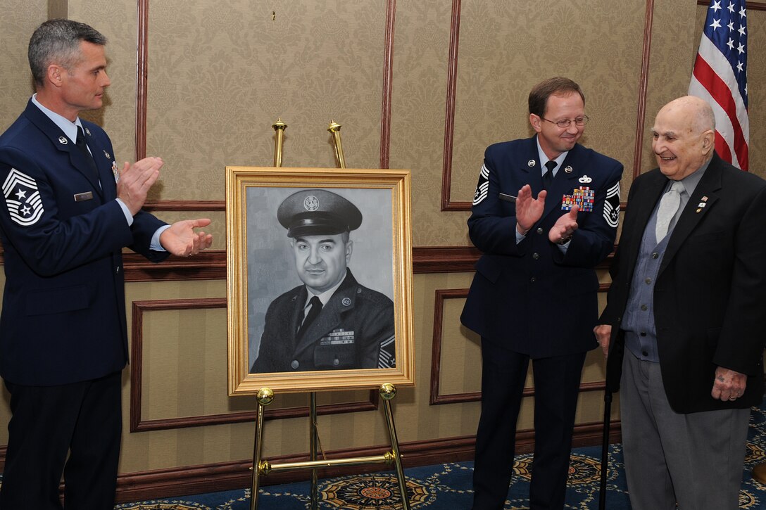 LANGLEY AIR FORCE BASE, Va. -- Chief Master Sgt. Charles Anderson, 633d Air Base Wing command chief, and Chief Master Sgt. Terry Rethamel, Langley Chief's Group president, applaud during the unveiling of retired Chief Master Sgt. Gabriel Christie's portrait Feb. 2. Chief Christie is one of the first 625 Airmen promoted to chief master sergeant, known as "Charter Chiefs."  (U.S. Air Force photo/Senior Airman Zachary Wolf)