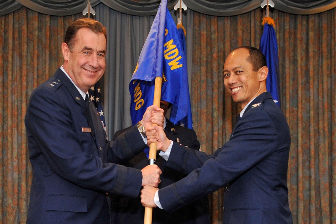 Major Gen. Gar Graham, 79th Medical Wing commander, passes the guidon to Col. Rudolph Cachuela, 779th Medical Group commander, during the change of commander ceremony on Jan. 22, 2010. Col. Cachuela hails from the Office of the Surgeon General in Arlington, Va. and will be serving as the new 779 MDG commander. (U.S. Air Force photo by Staff Sgt. Renae L. Kleckner)(released) 